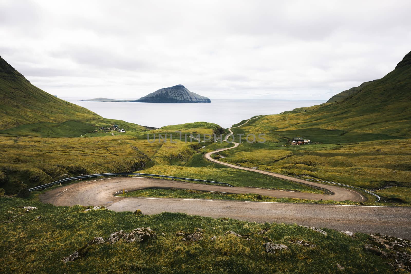 Winding road on Faroe Islands towards the village of Nordradalur by nickfox