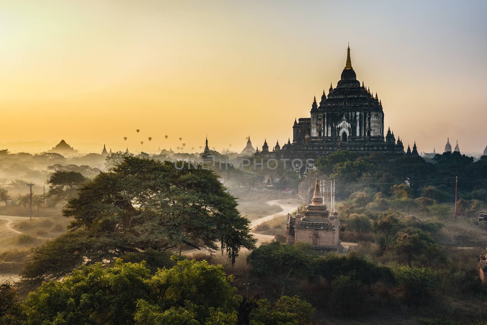 Scenic sunrise with hot air balloons aboveThatbyinnyu temple in Bagan, Myanmar. Bagan is an ancient city with thousands of historic buddhist temples and stupas.