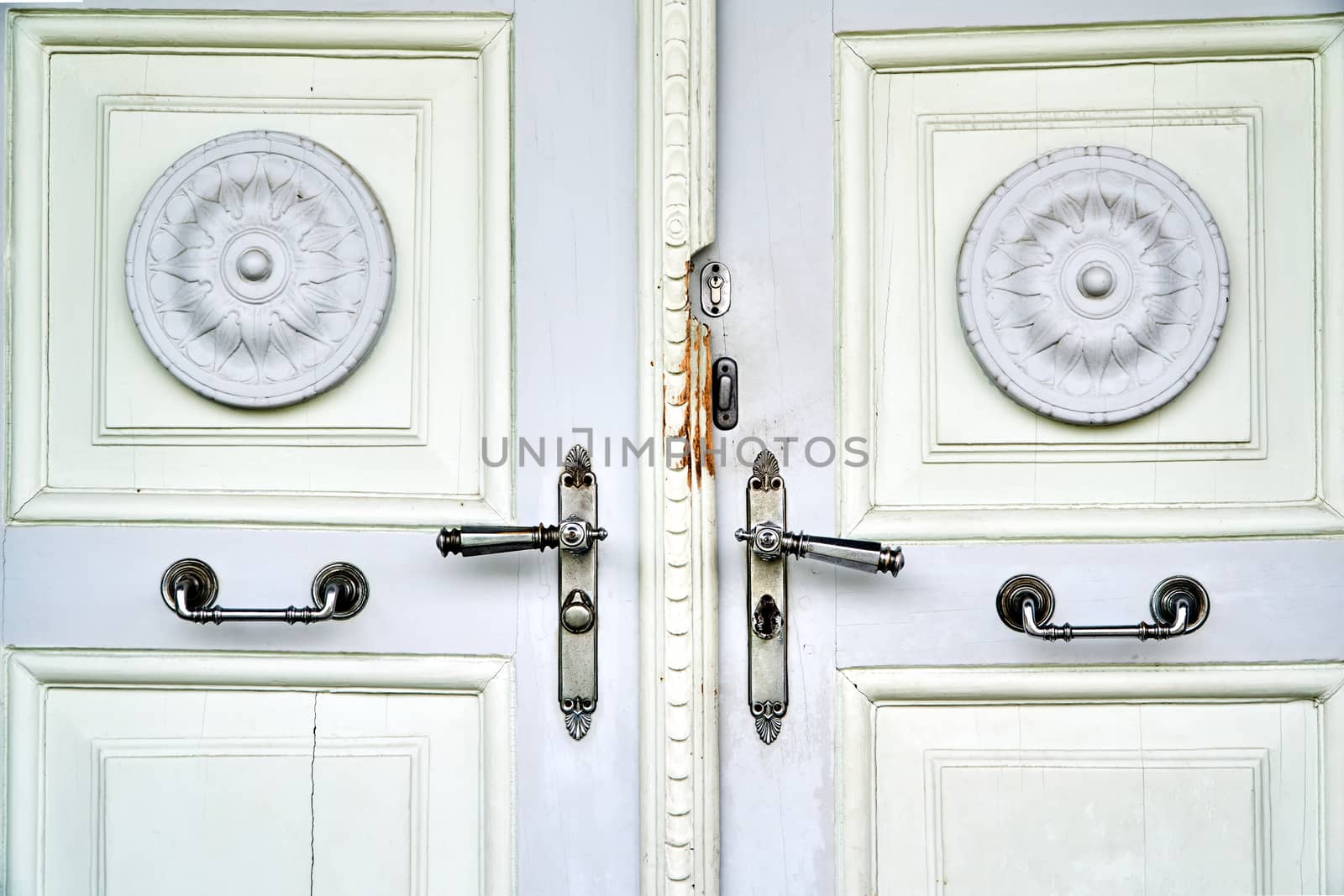 Wooden, antique door with metal door handles in the Czech Republic