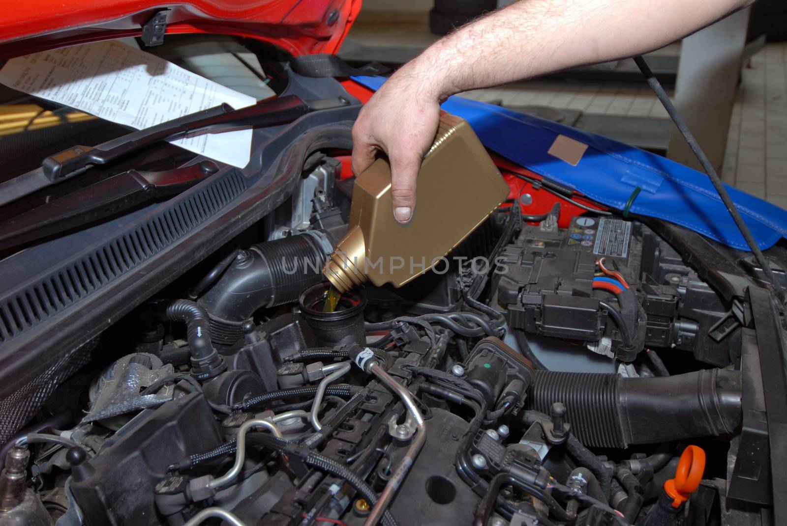 service from buckets pours motor oil