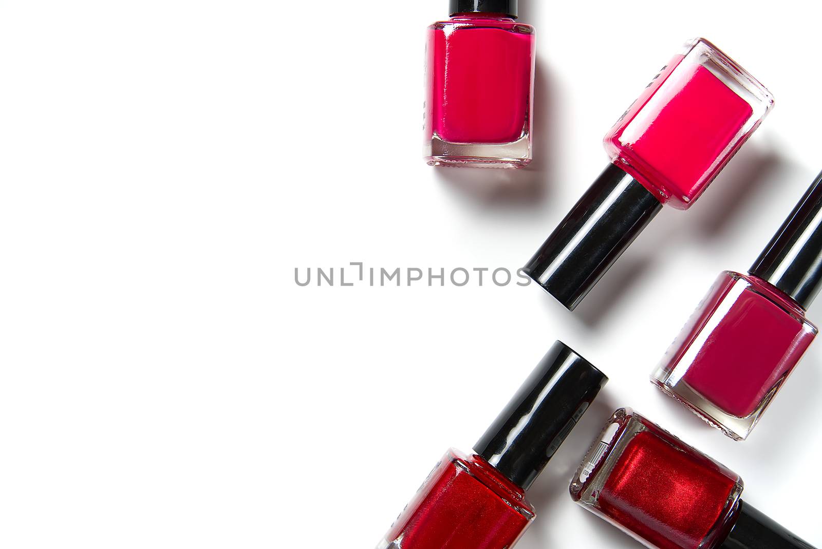 Nail work flat lay concept. bottles of colorful nail polish on white background. Nail polishes isolated on white background. Beauty background. by PhotoTime
