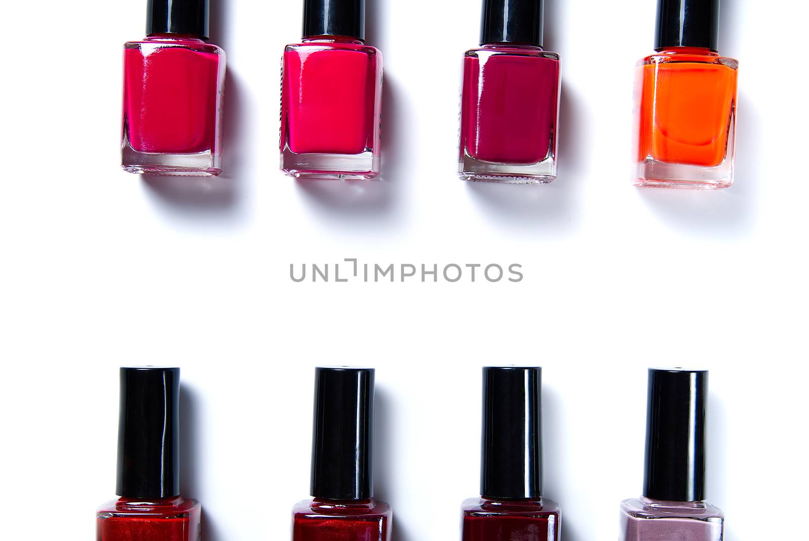 Nail work flat lay concept. bottles of colorful nail polish on white background. Nail polishes isolated on white background. Beauty background