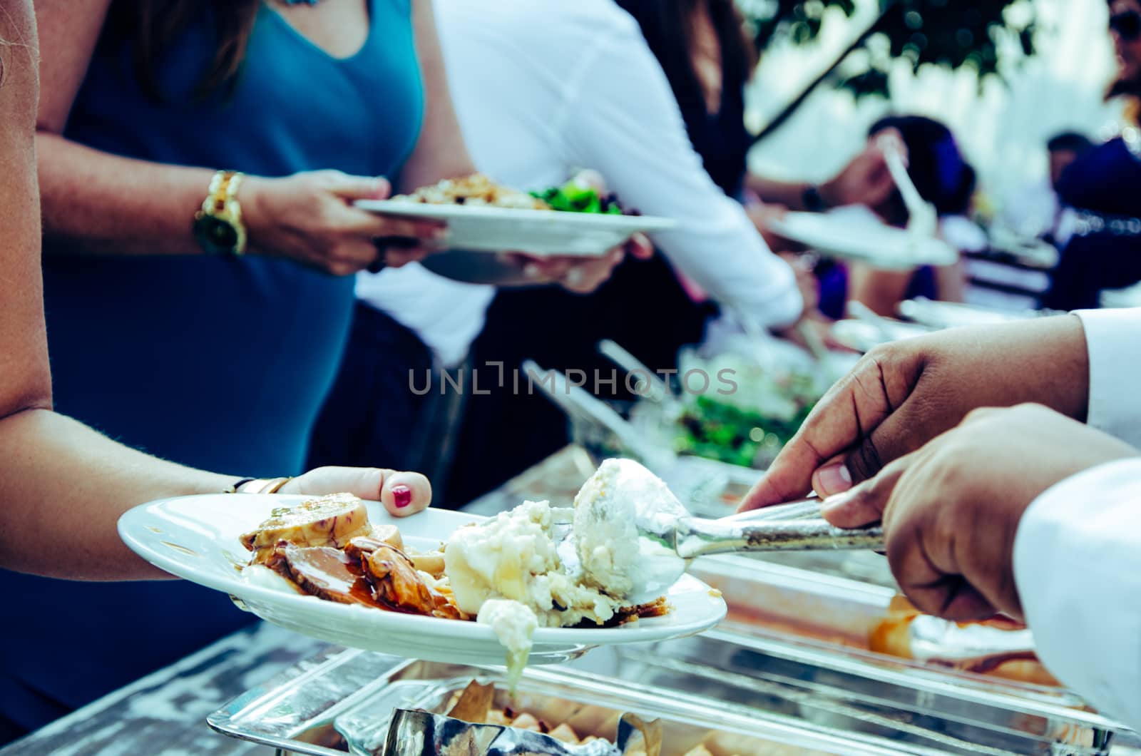 People eating from the wedding buffet