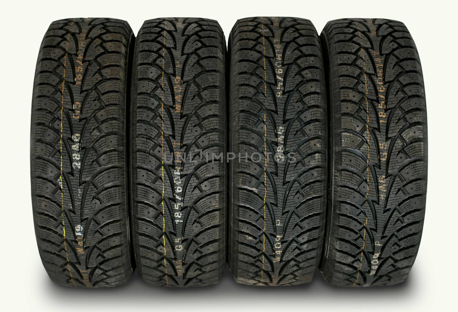 four winter tires isolated on white background