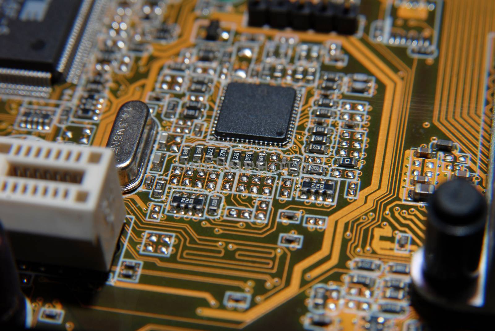 Electronic chip on circuit board. Macro, shallow DOF
