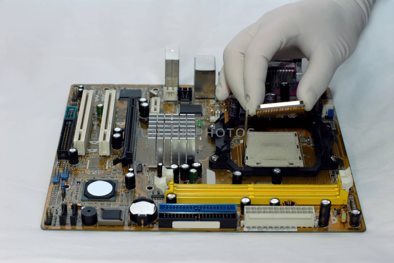 woman's hand in glove sets the CPU to motherboard