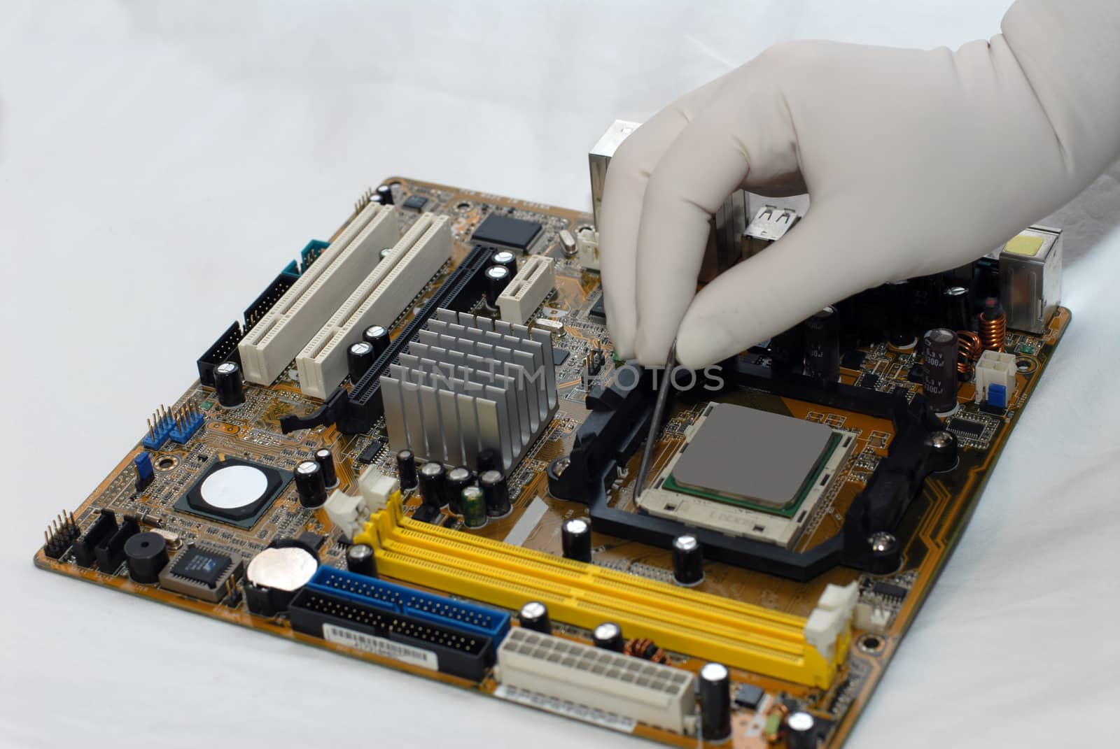 woman's hand in glove sets the CPU to motherboard