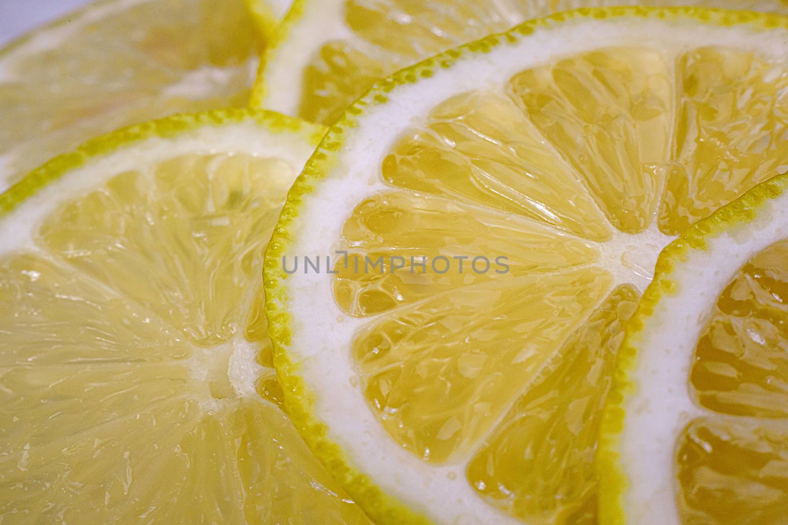 Lemon background. Close up view of lemon slices. Citrus texture. by 9parusnikov