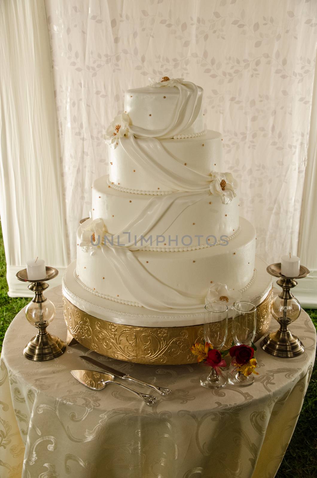 A white wedding cake with candles