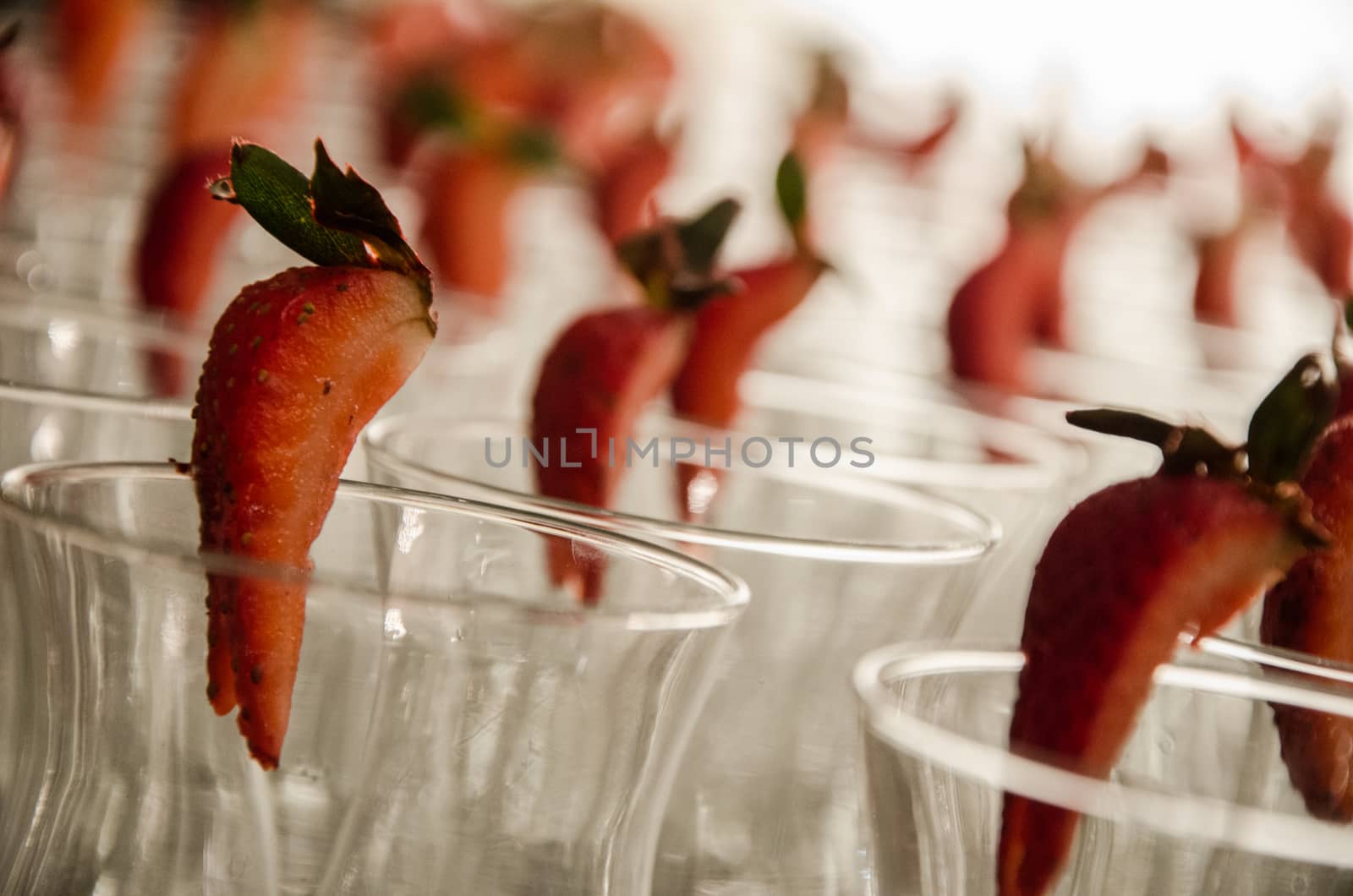 Strawberries and crystal glasses, decoration of a wedding table