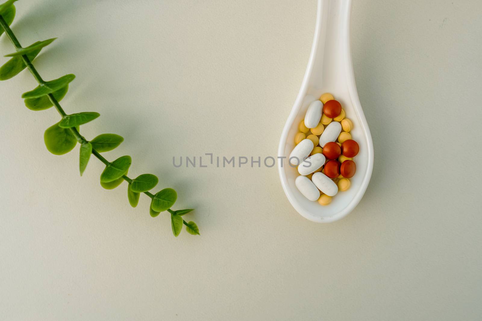 Mixed of pill or tablet medicine on white spoon on white background. Health care medicine cure disease lifestyle trend concept.