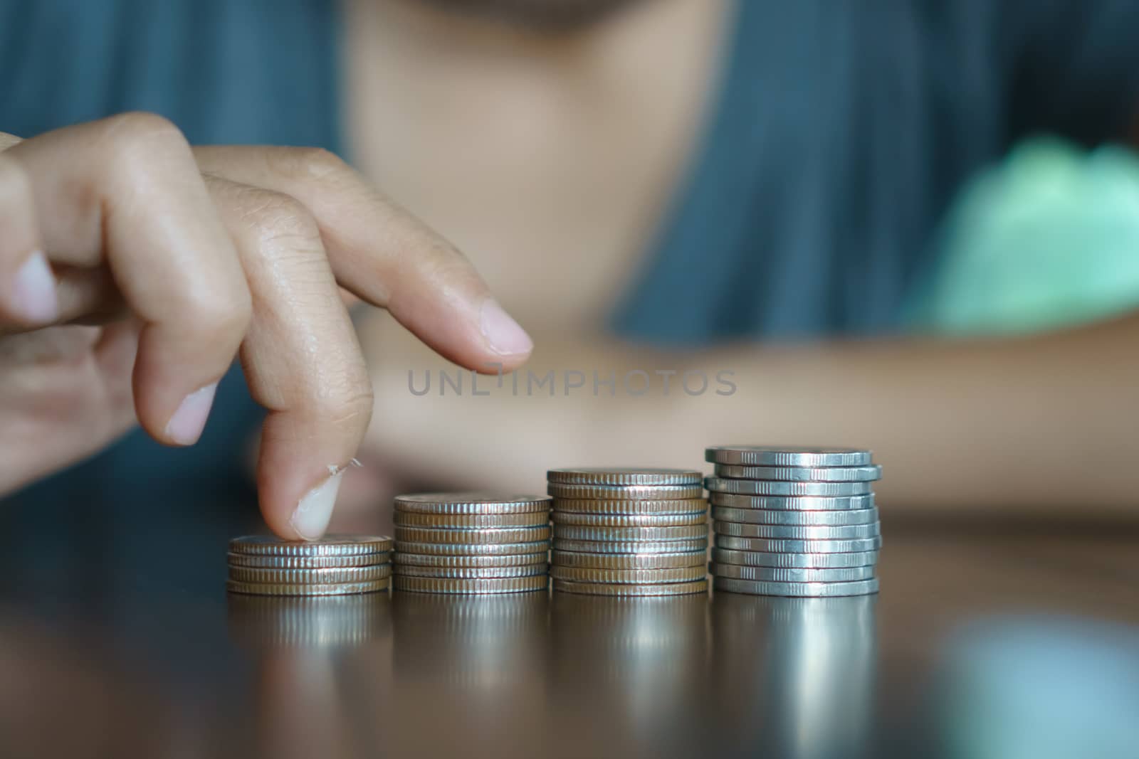 Business financial success concept. Gold coins on table and green nature bokeh background.Bullish market situation.