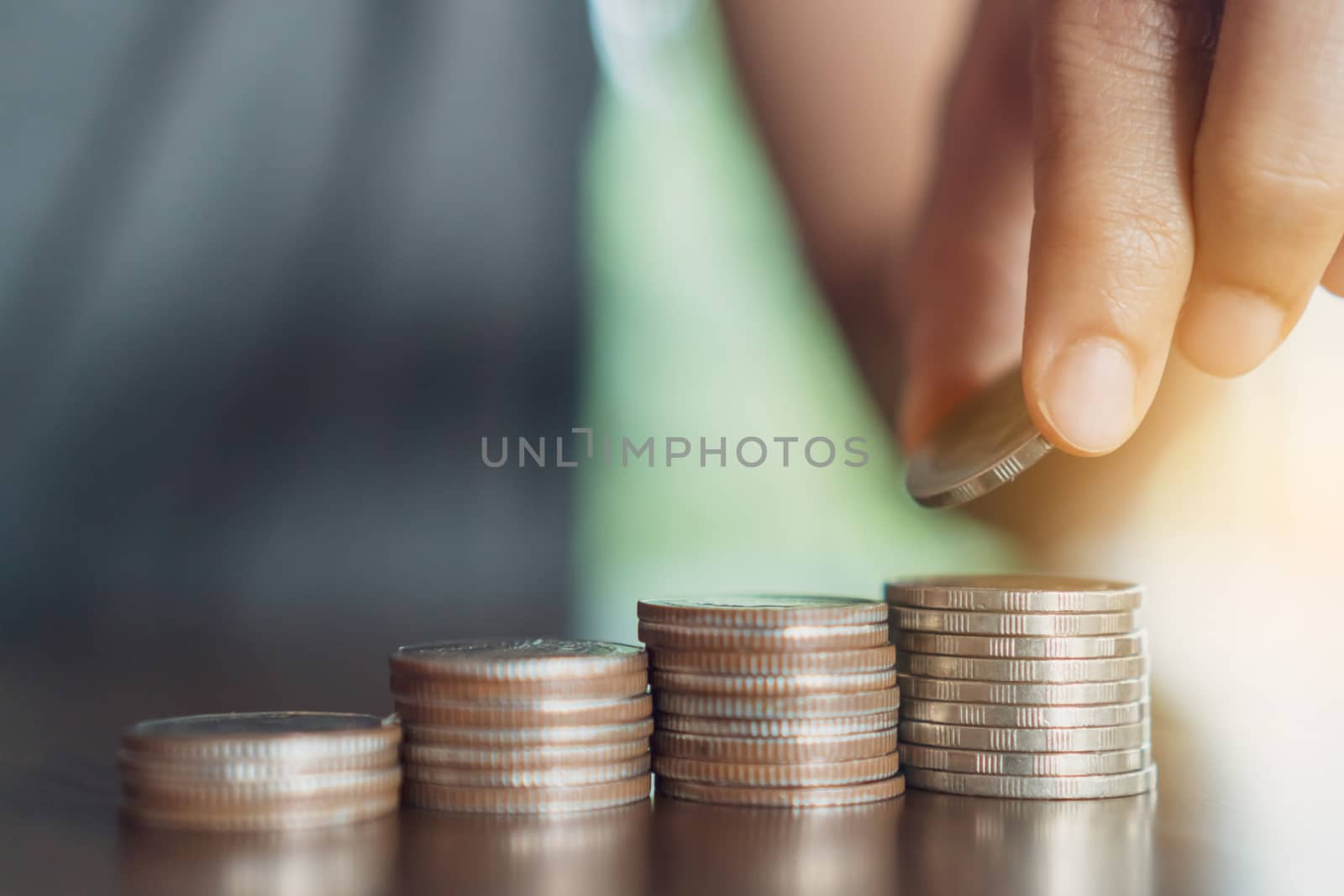 Business financial success concept. Gold coins on table and green nature bokeh background.Bullish market situation.