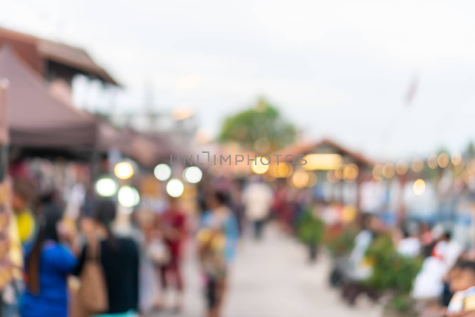 Blur the country river evening market Thai style with people relax and chill out bokeh background.