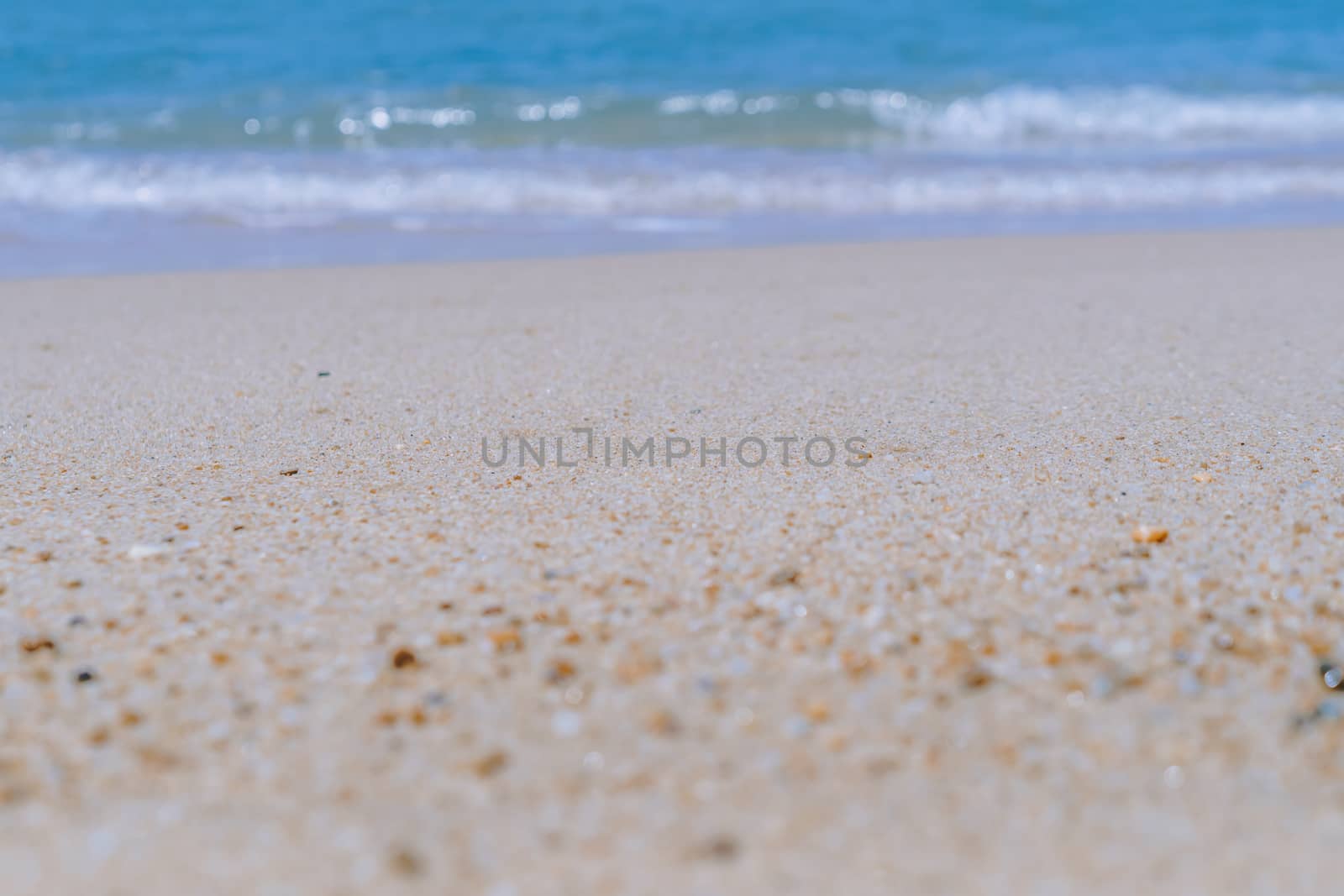 Tropical nature clean beach and white sand in summer with sun light blue sky and bokeh abstract  background.