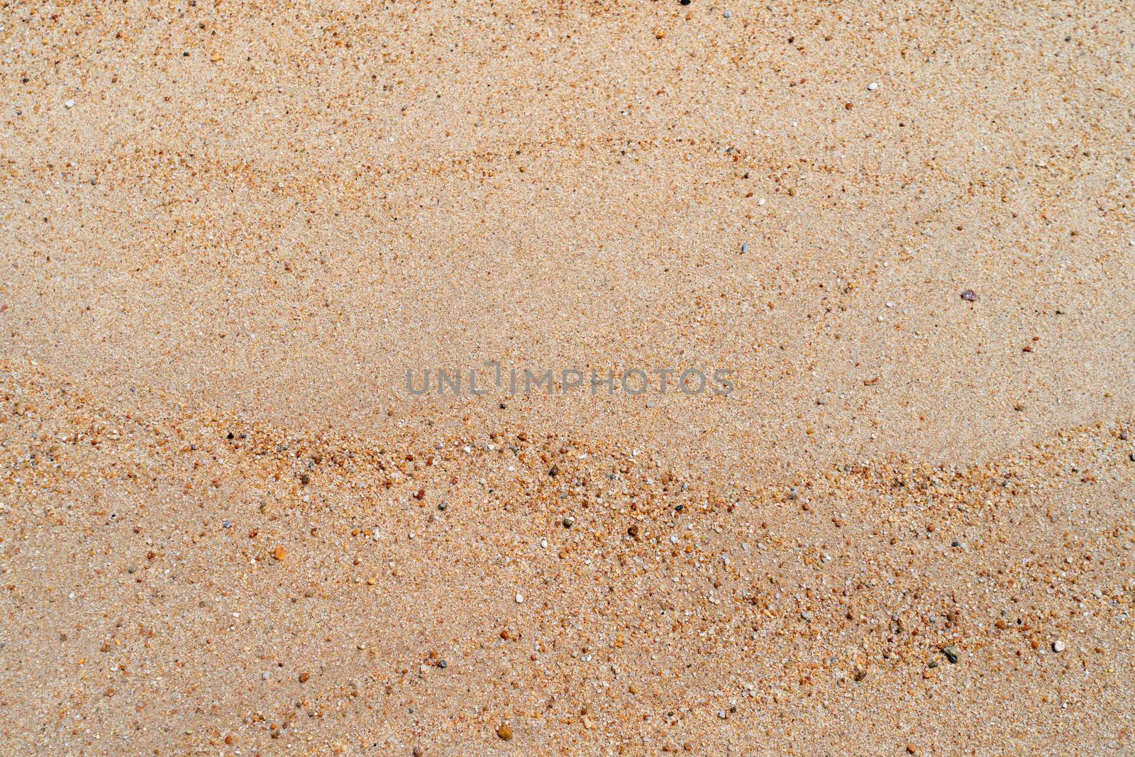 Brown sand texture background from fine sand with natural line wave on it. by Suwant