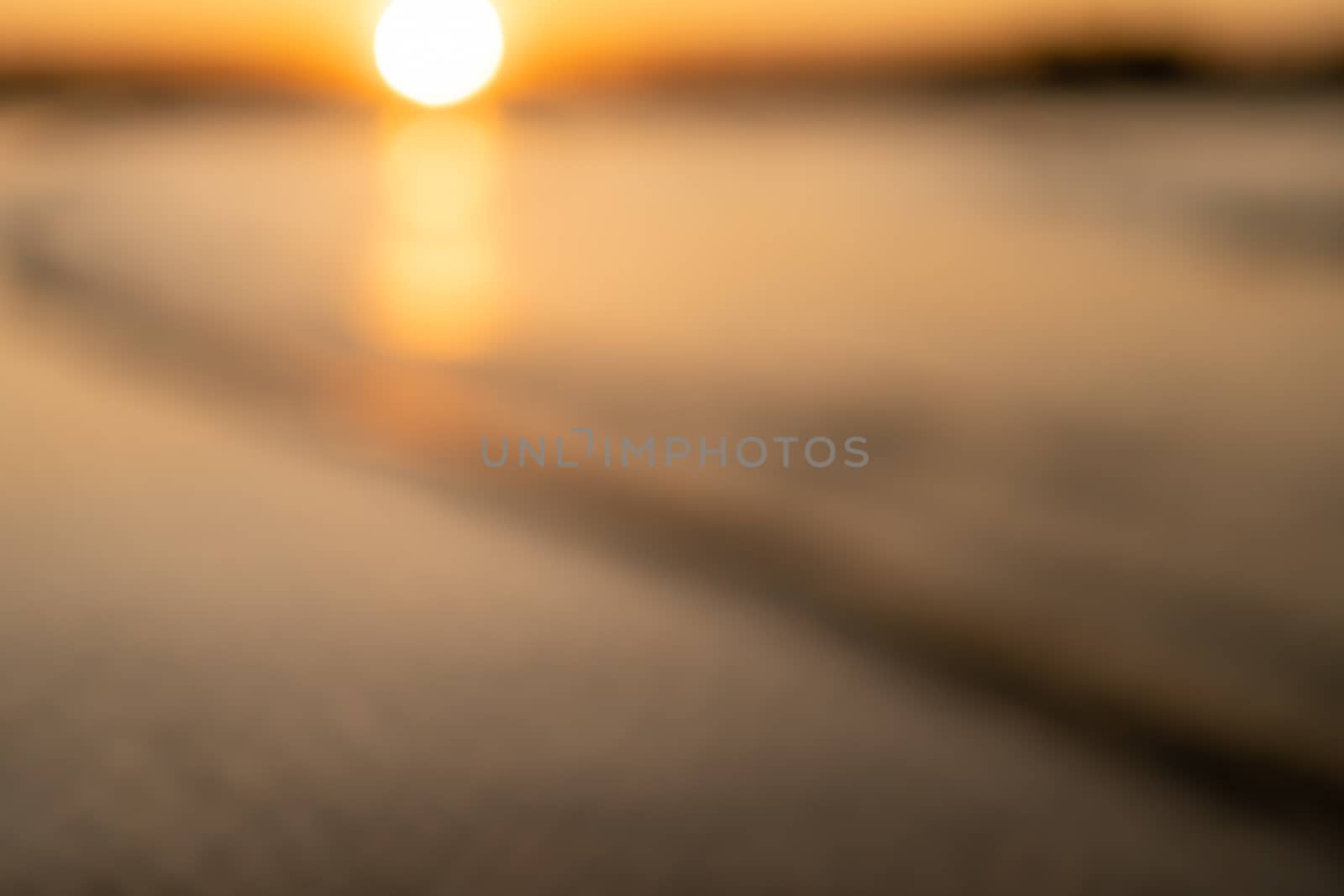 Blur beach with bokeh orange sunset theme color background.