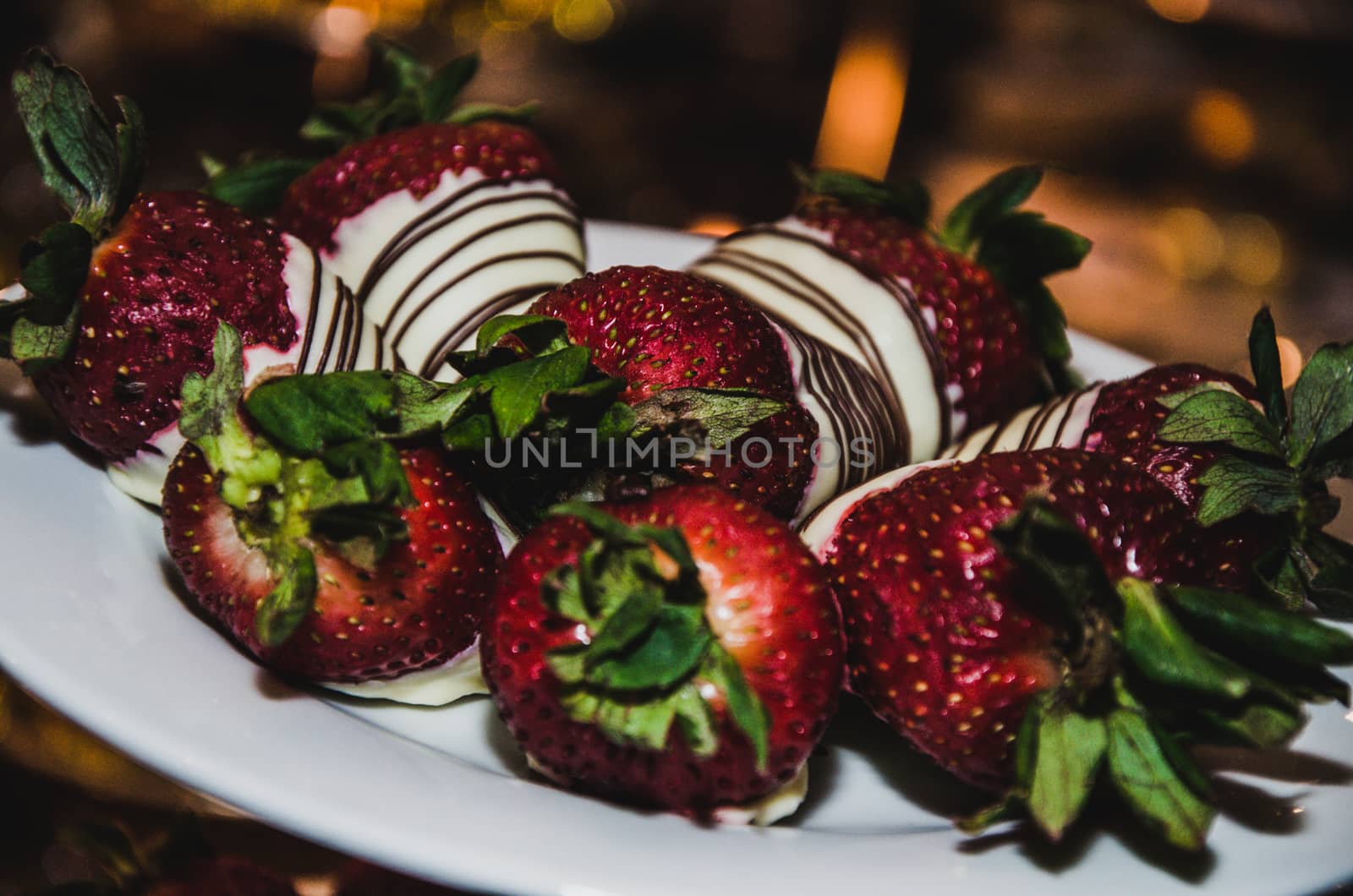 Strawberries with chocolate topping on the sweet table of a wedding