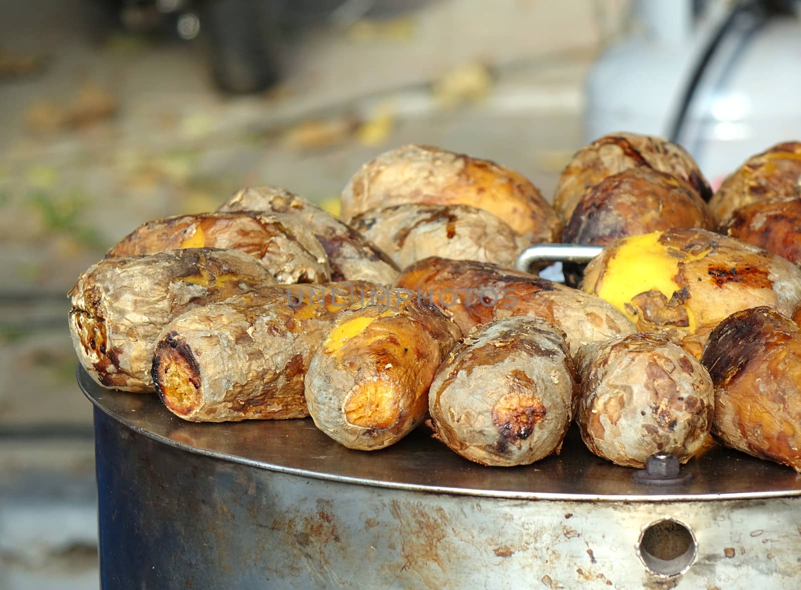 Freshly baked sweet potatoes are kept warm on top of the oven