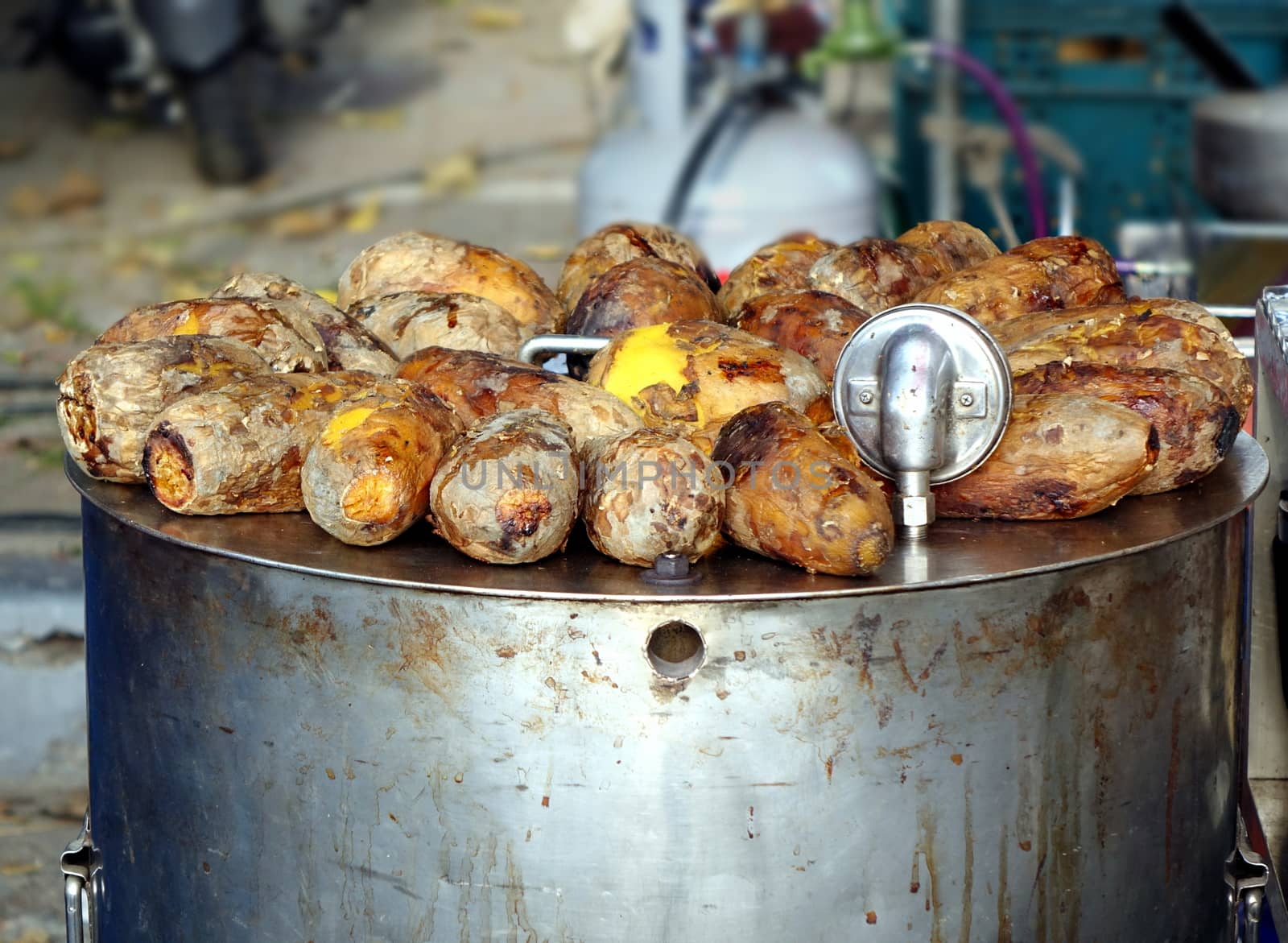 Freshly baked sweet potatoes are kept warm on top of the oven