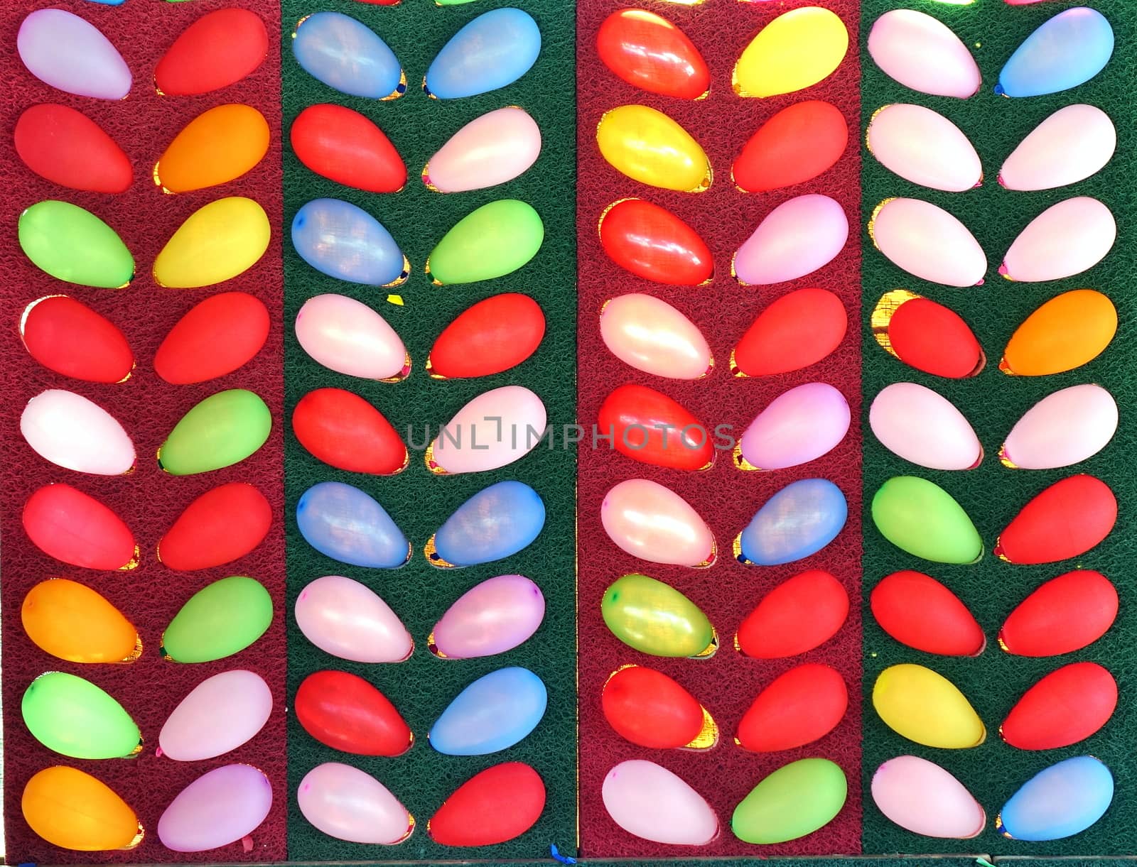 Colorful balloons at an outdoor game. You have to hit them with a dart and pop them.