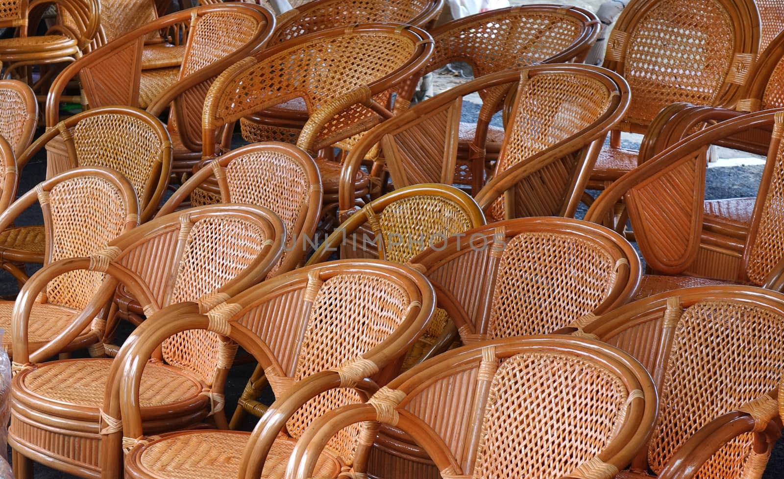 Handcrafted rattan and bamboo chairs for sale at an outdoor market