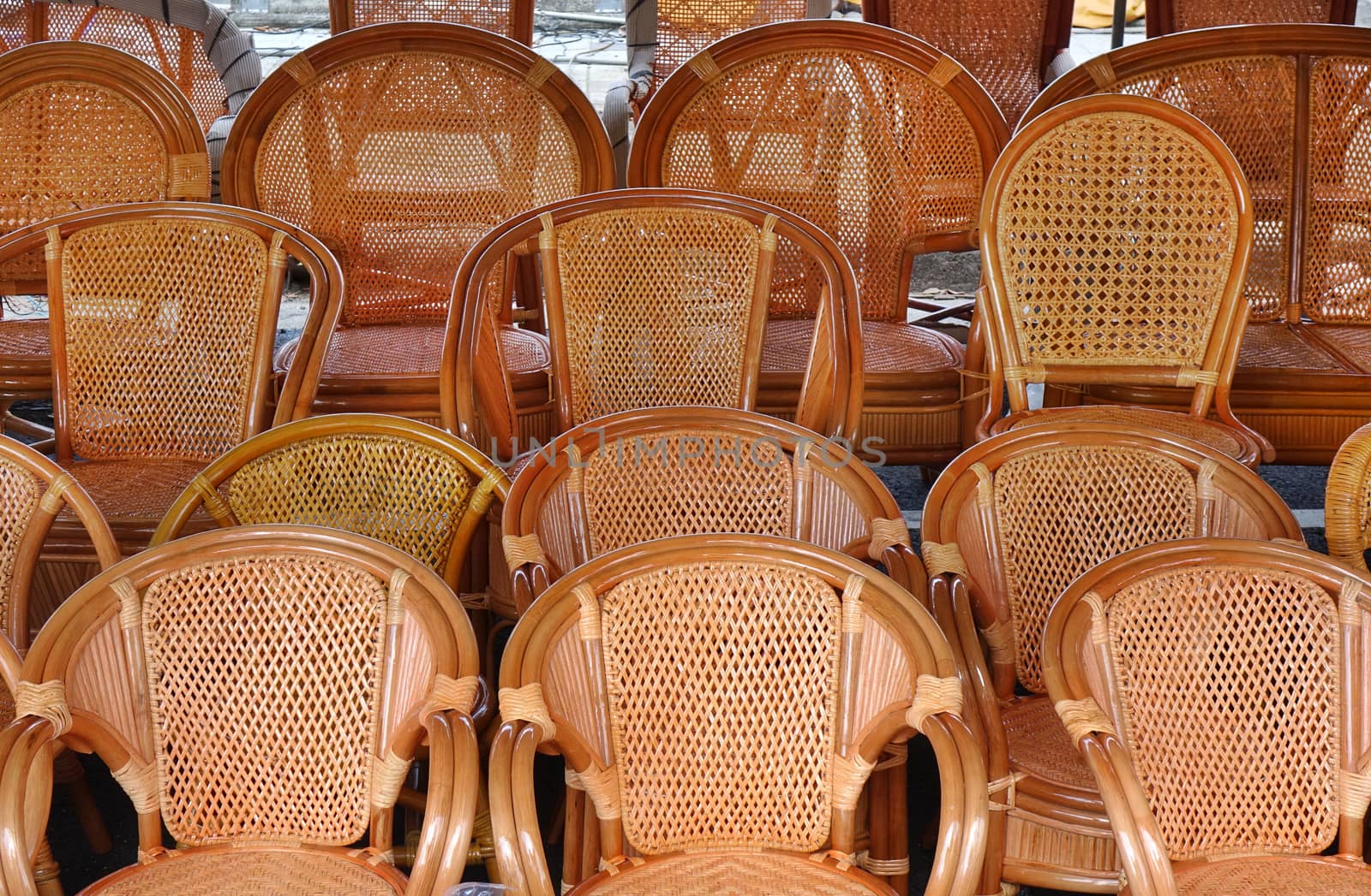 Handcrafted rattan and bamboo chairs for sale at an outdoor market