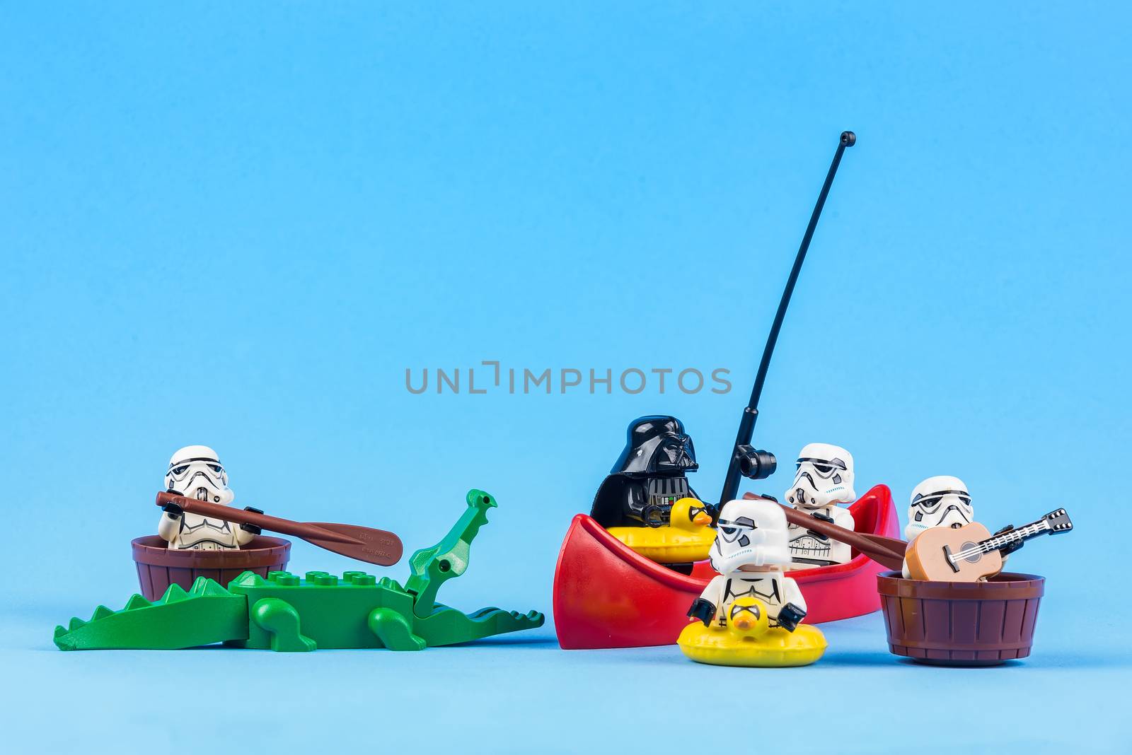 Bangkok, Thailand - June, 08, 2010 : Lego Star Wars is rowing away from the crocodiles isolated on a blue background at Bangkok, Thailand. Fun concept