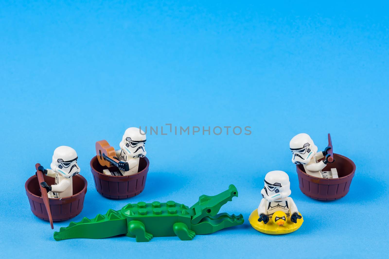 Bangkok, Thailand - June, 08, 2010 : Lego Star Wars is rowing away from the crocodiles On a blue background at Bangkok, Thailand. Fun concept