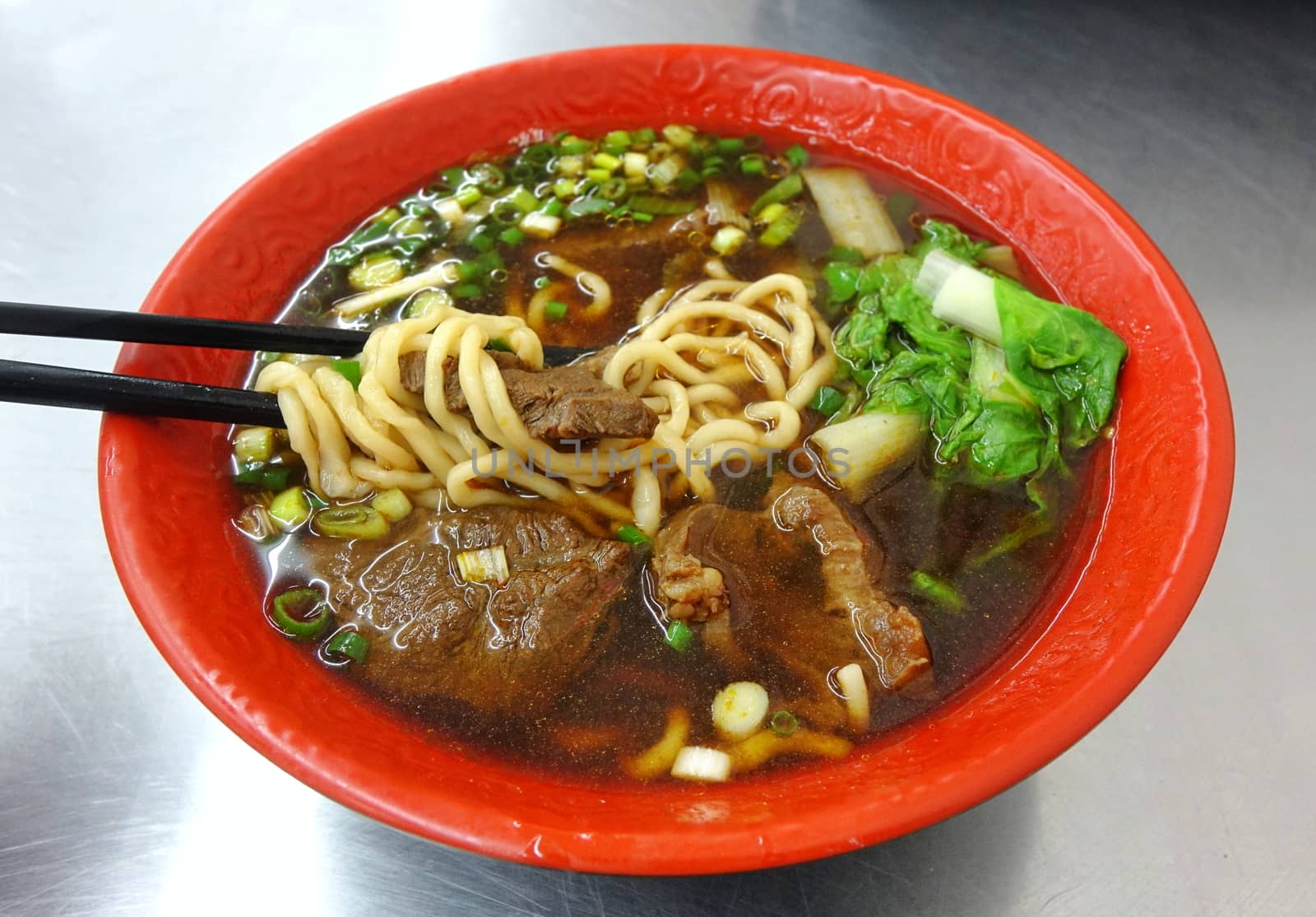 Braised beef in broth with noodles and chives is a popular dish in Taiwan