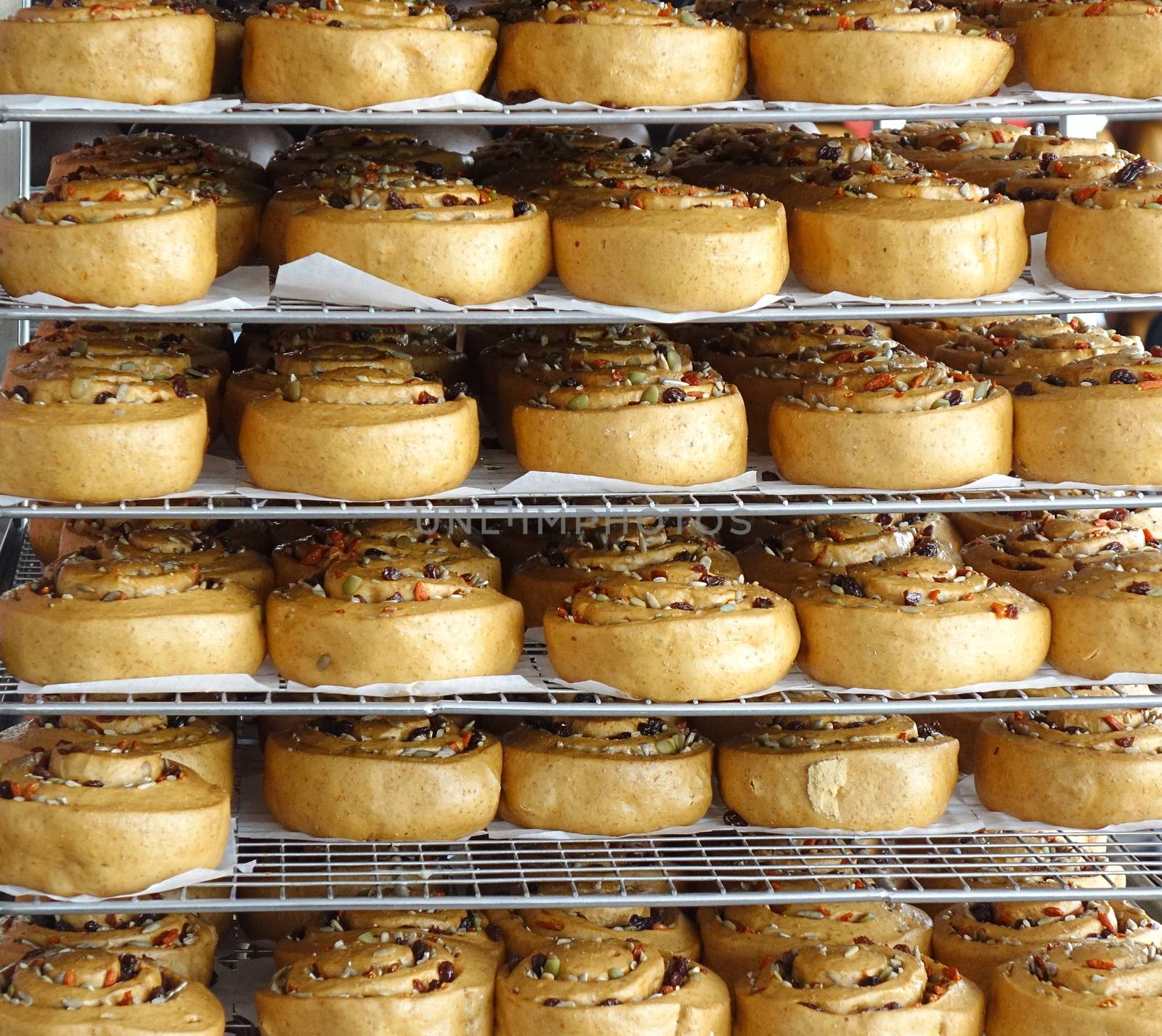 Chinese steamed buns with dried fruits and nuts on cooling racks
