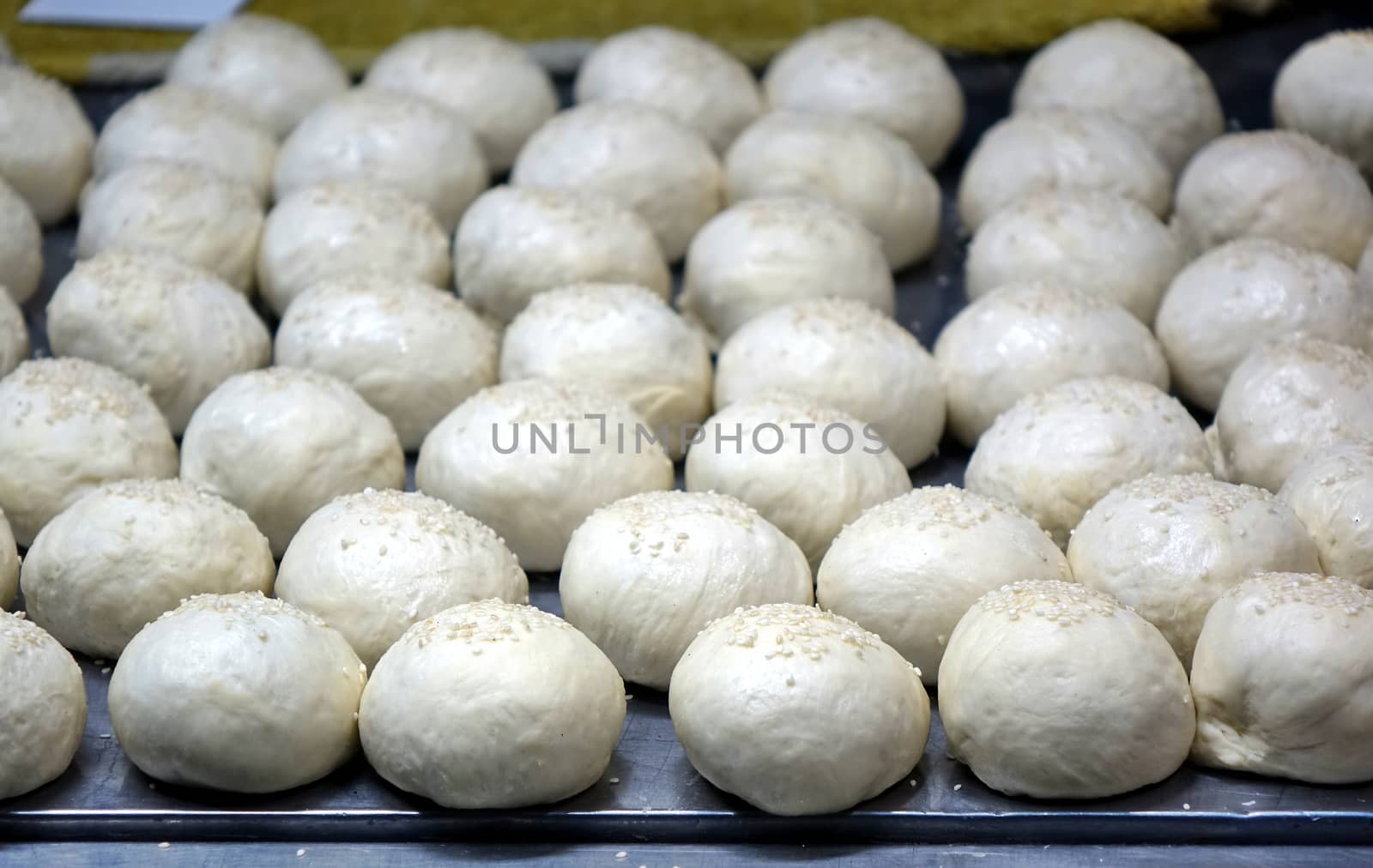 Chinese buns with sesame sprinkled on top are ready for baking
