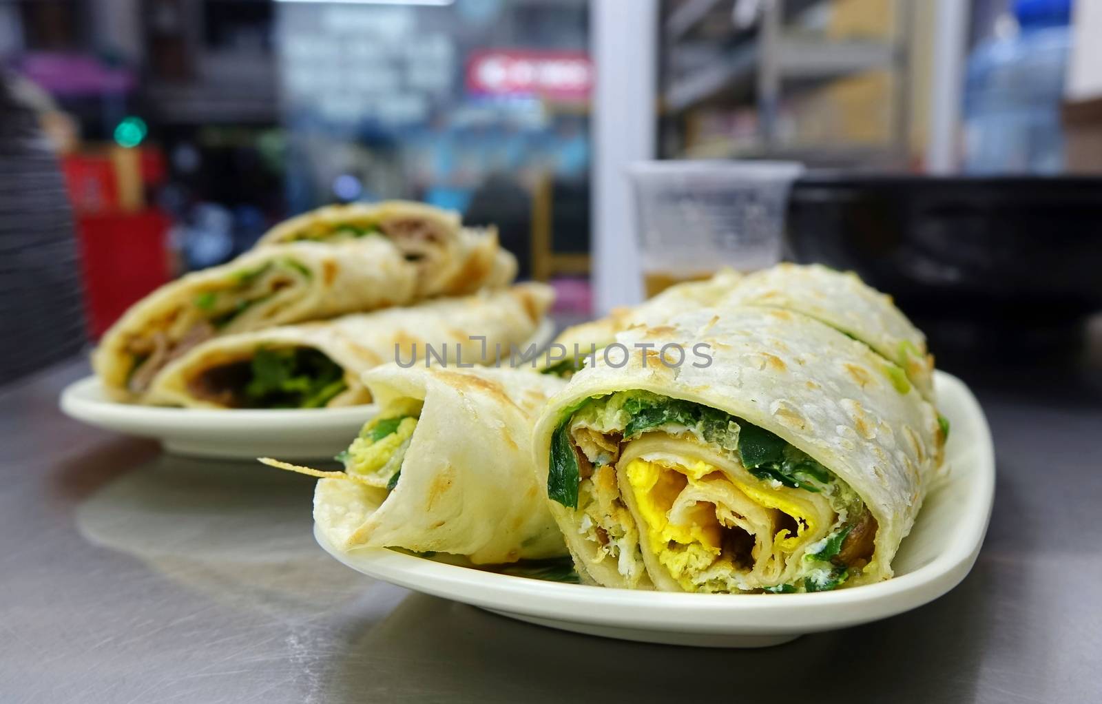Rolled pancakes stuffed with green chives and egg is a popular Chinese snack