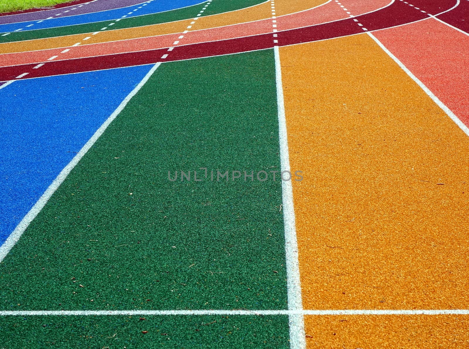 Running tracks in several bright colors with white lane markings
