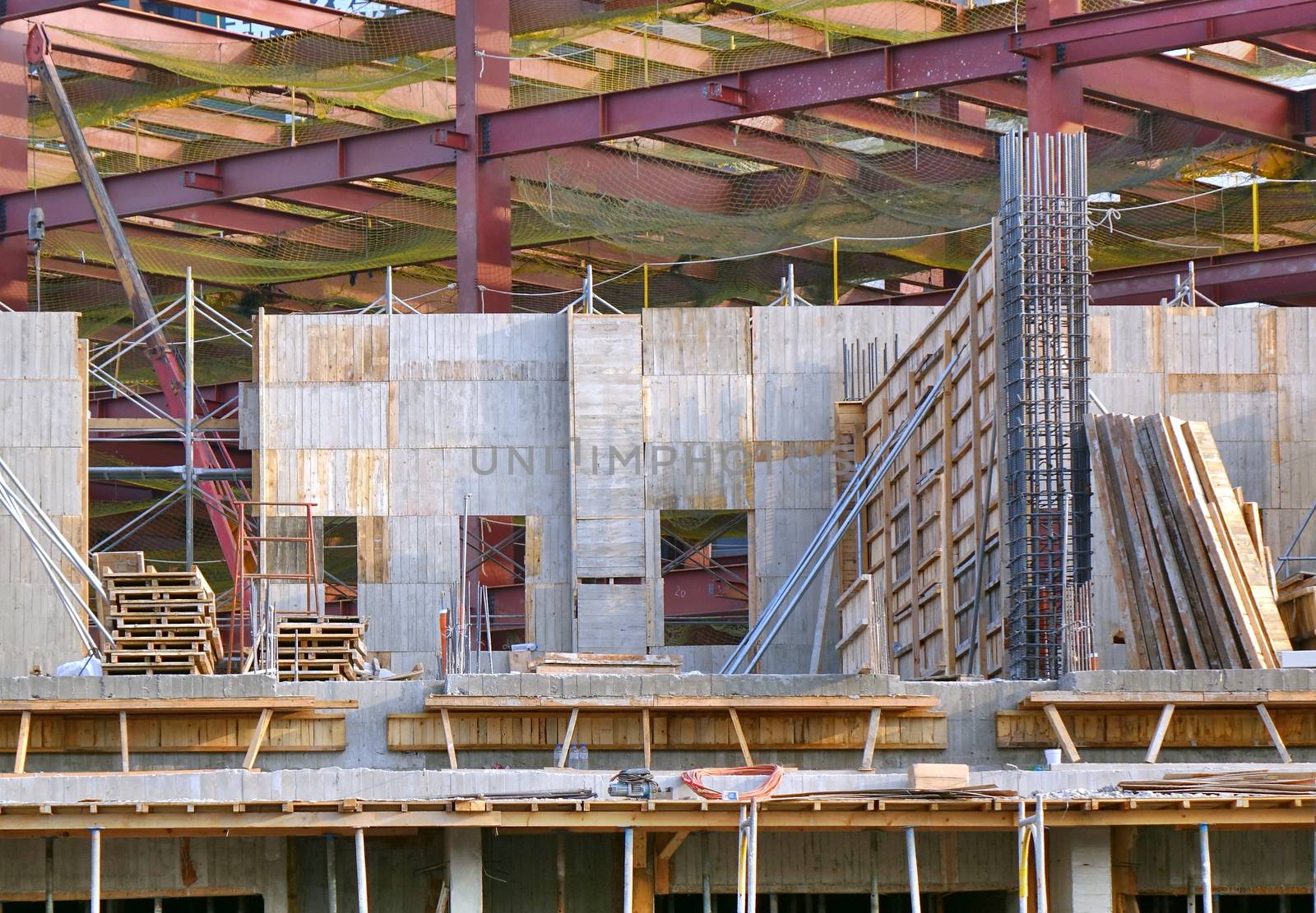Construction site with large steel girders and timber framing
