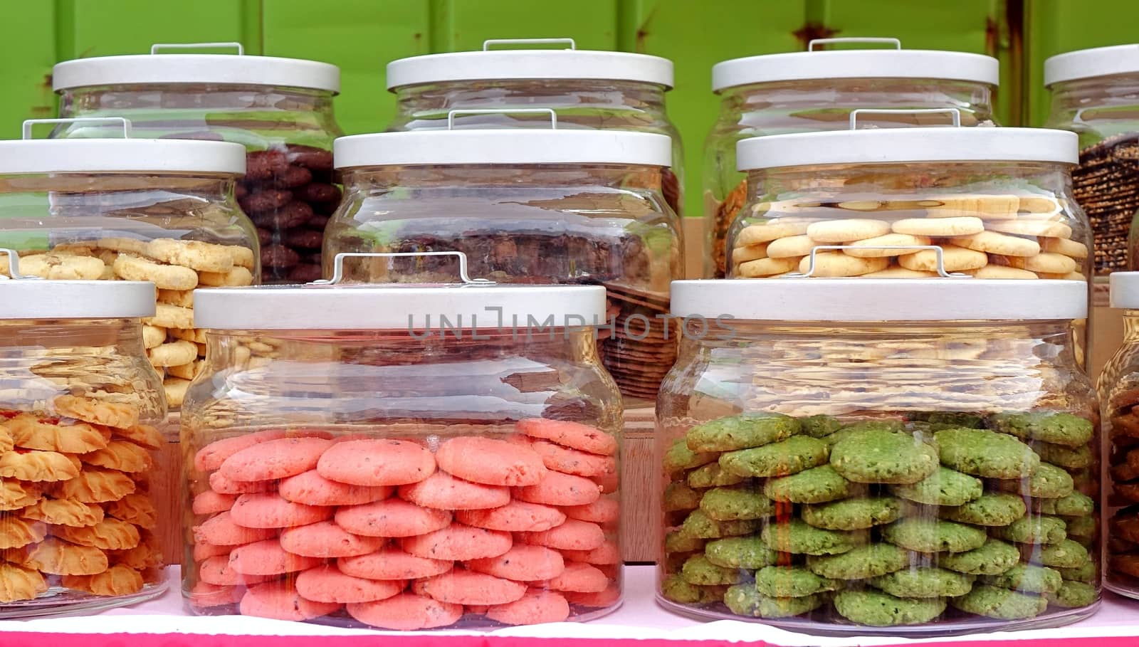 A colorful selection of cookies sold from large glass jars.
