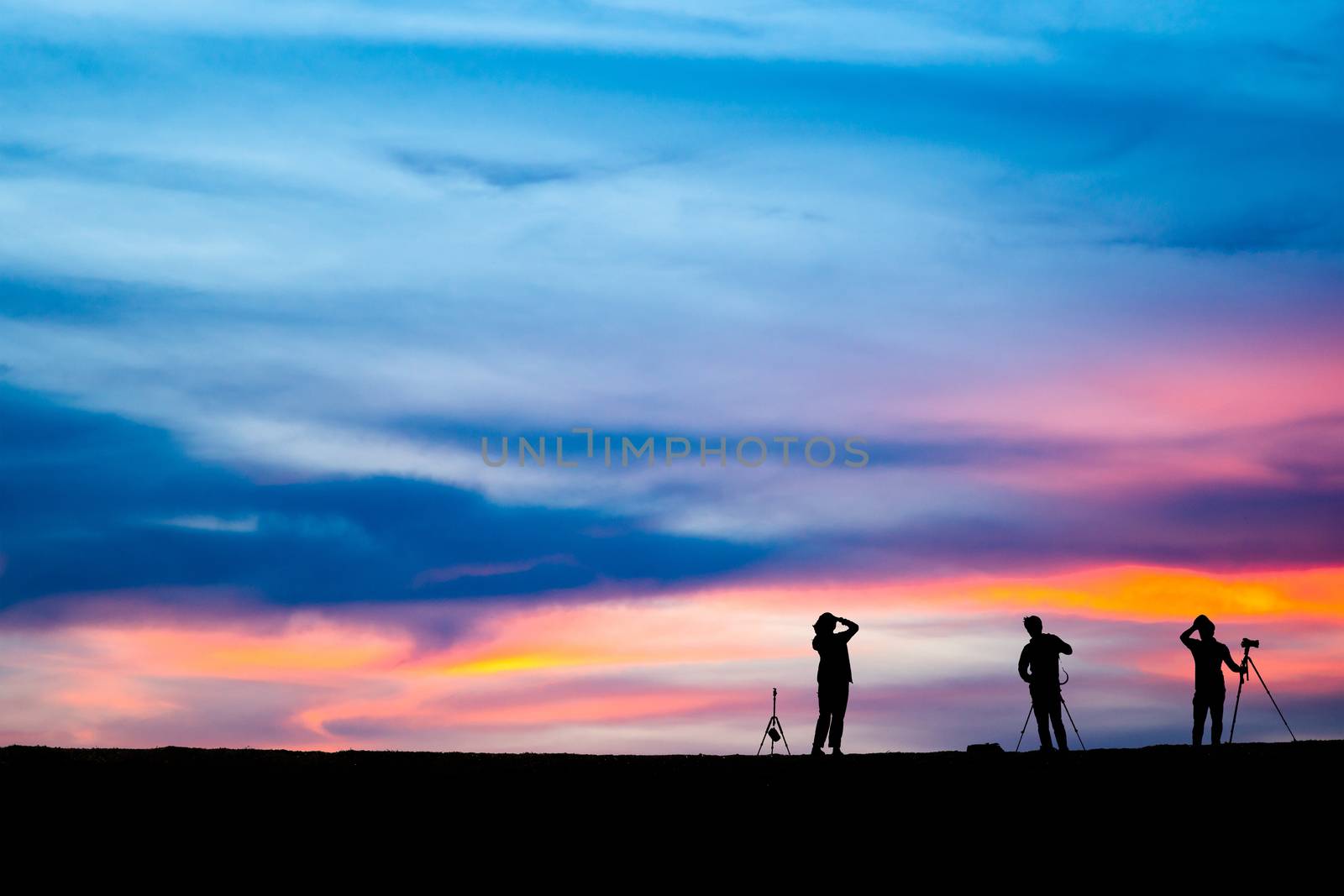 Silhouette of man hold up hands on the peak of mountain,success  by freedomnaruk