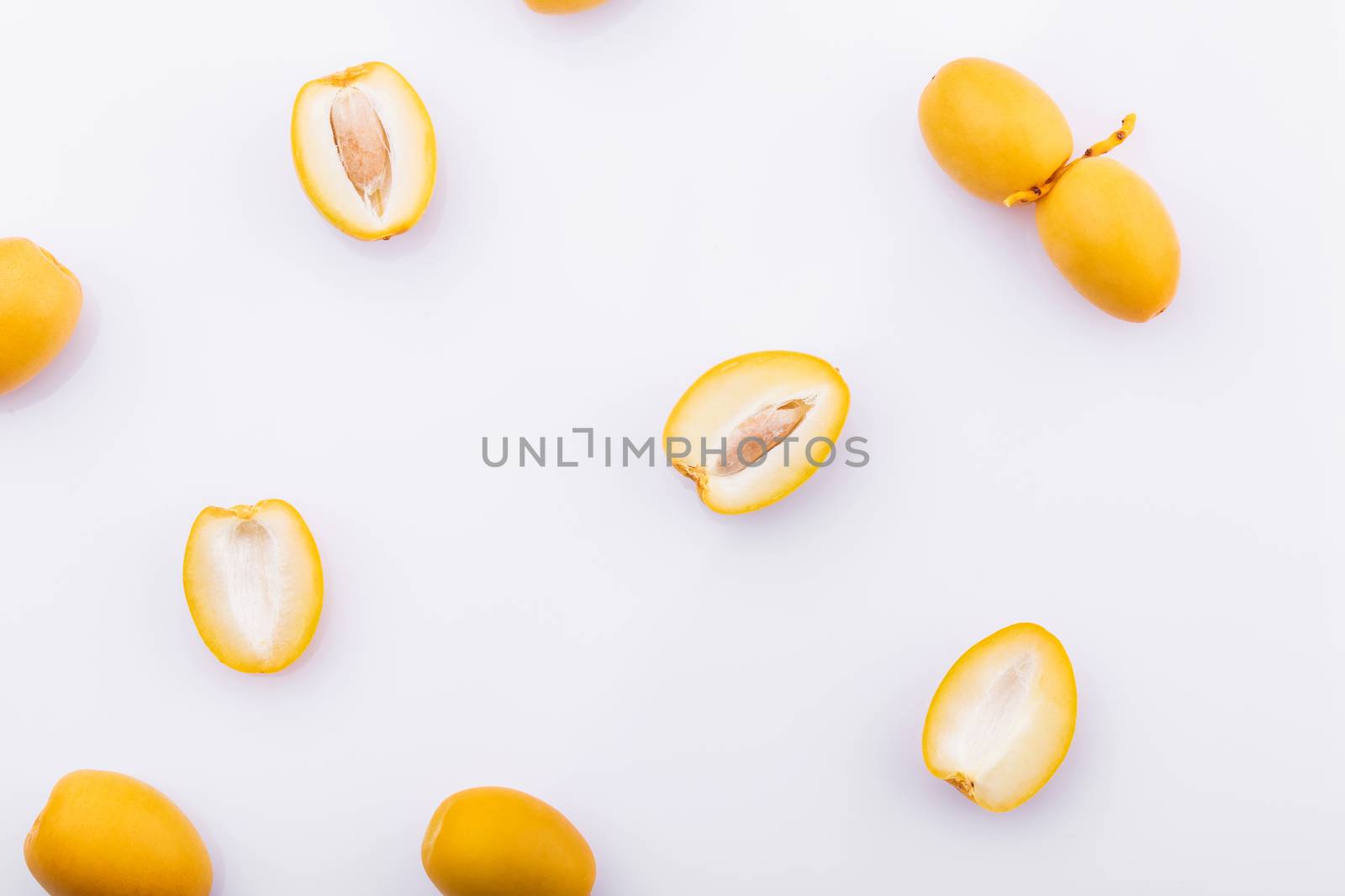 yellow date palm fruit on white background