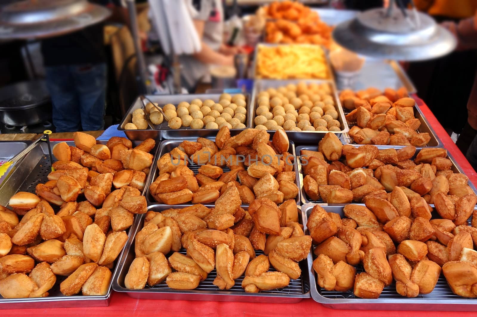 A market stall sells deep fried Chinese bread buns
