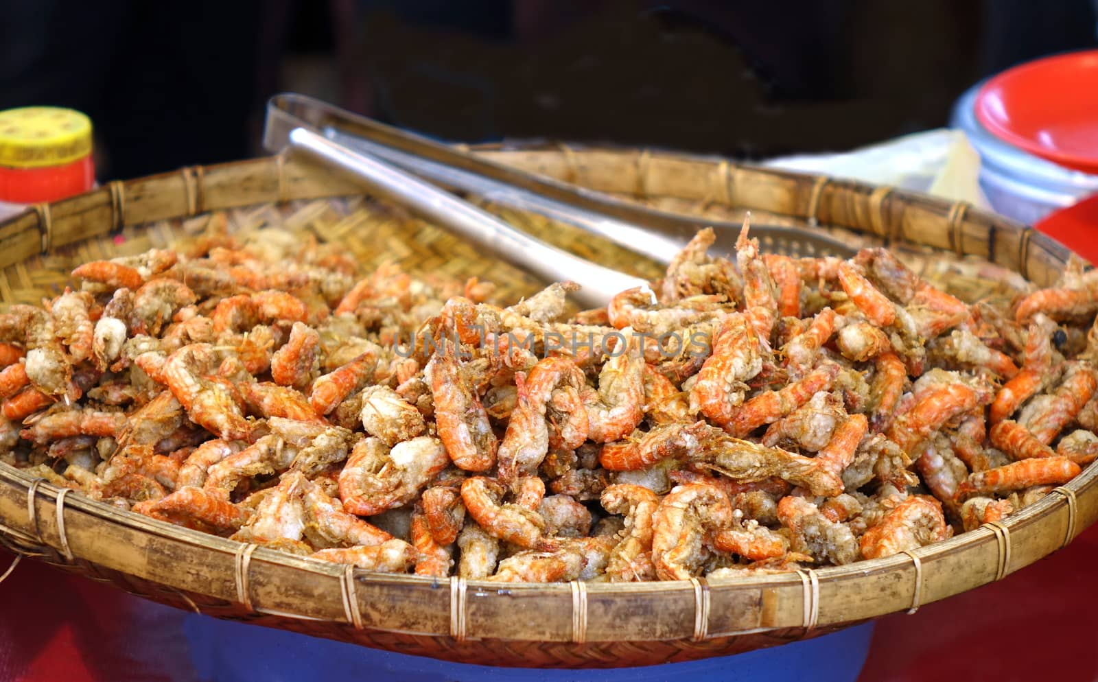A street vendor sells deep fried shrimps