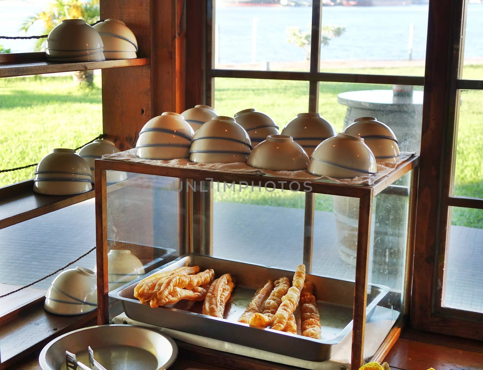 A stall sells Chinese fried breadsticks and bowls of soybean milk
