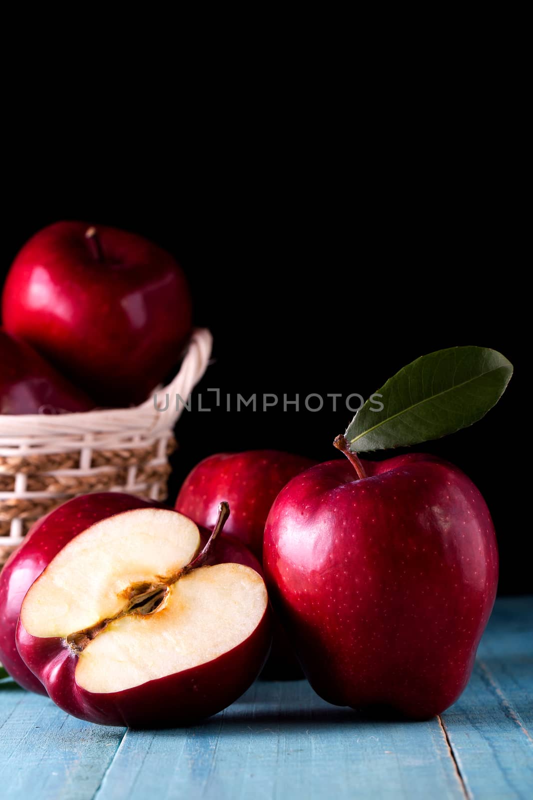 Red apples with leaves on the table by freedomnaruk