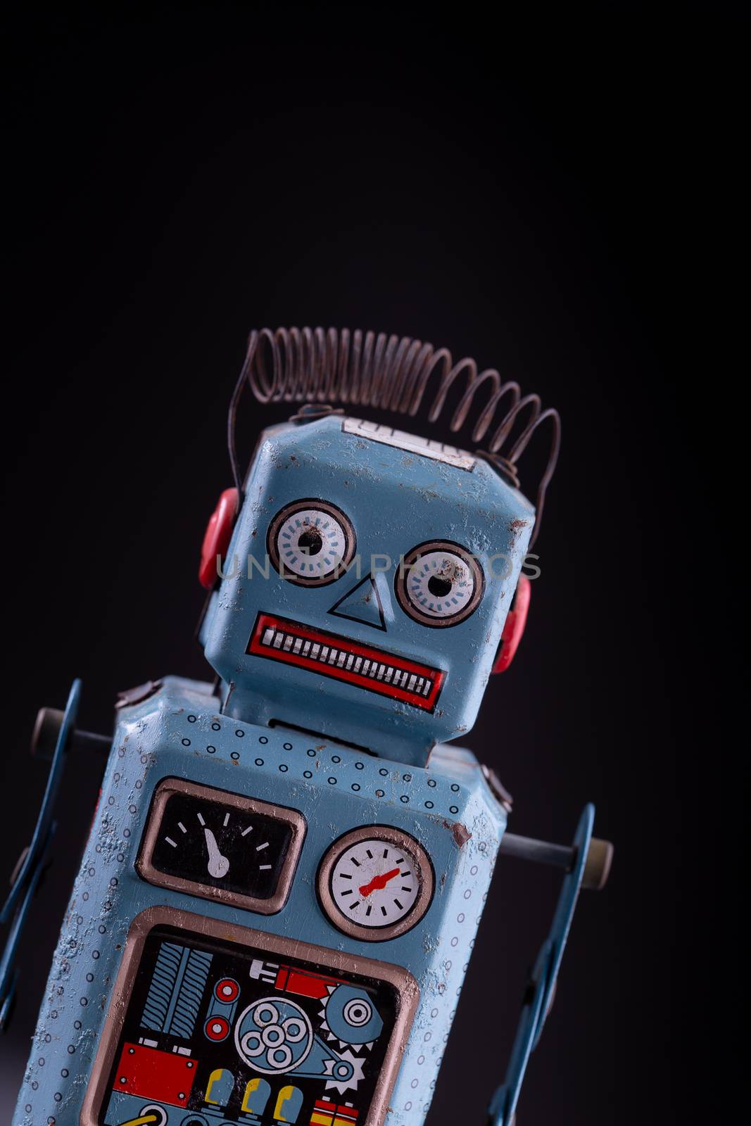 Vintage robot tin toy on yello background