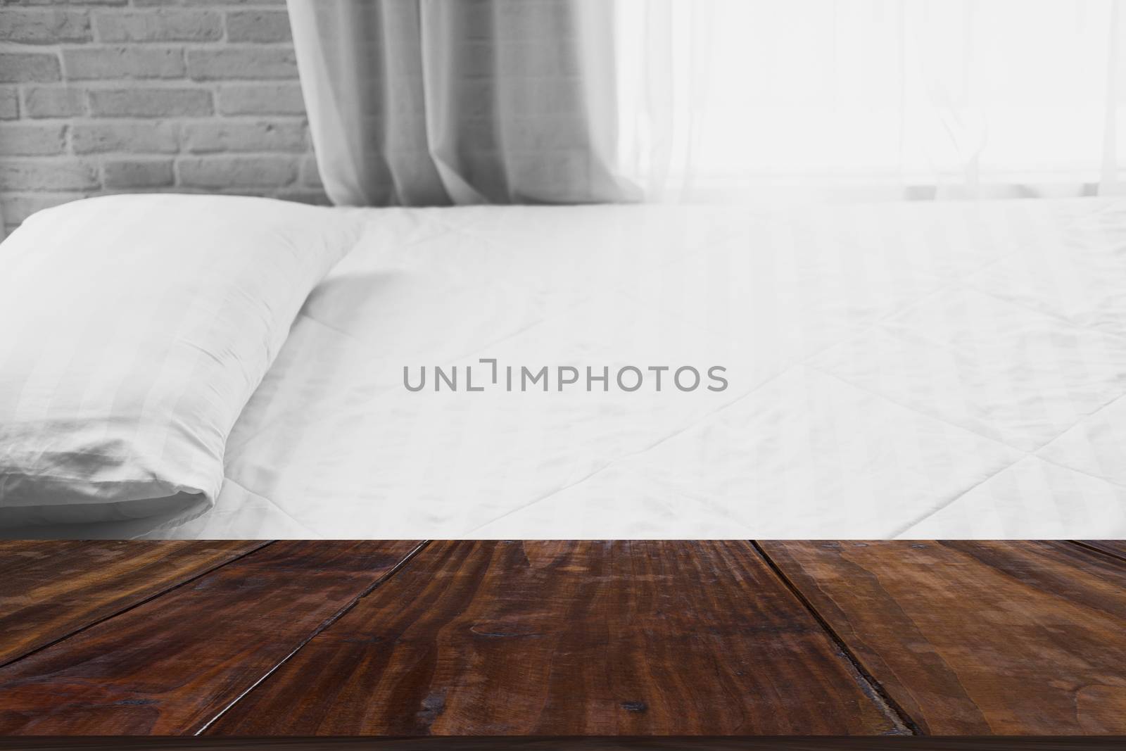 white pillow on mattress bed beside see through sheer window curtain