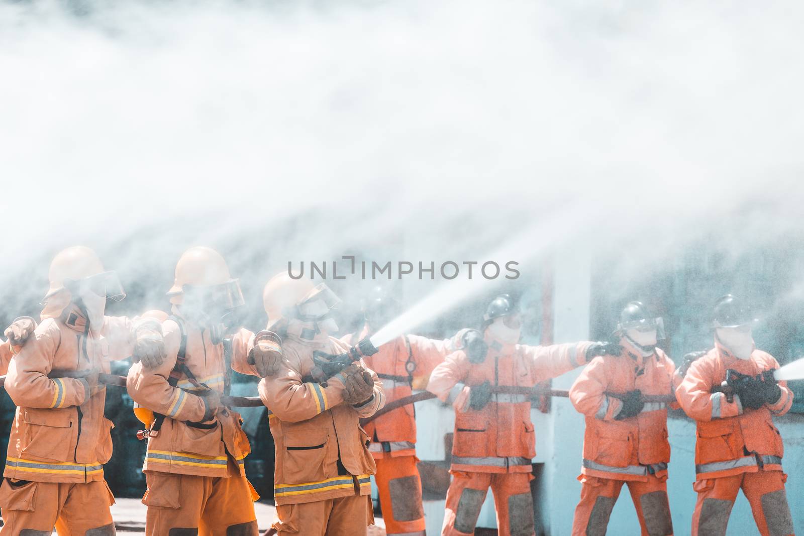 Fireman using water and extinguisher to fighting with fire flame by freedomnaruk