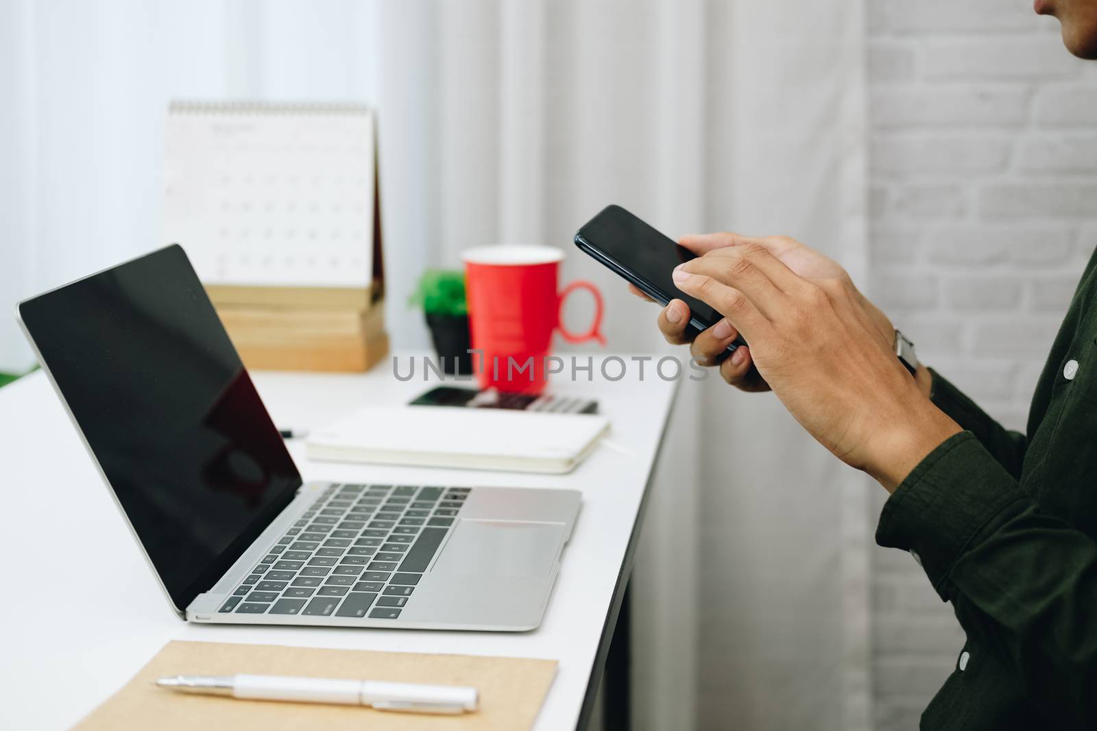 freelancer man businessman using mobile smartphone working at home office