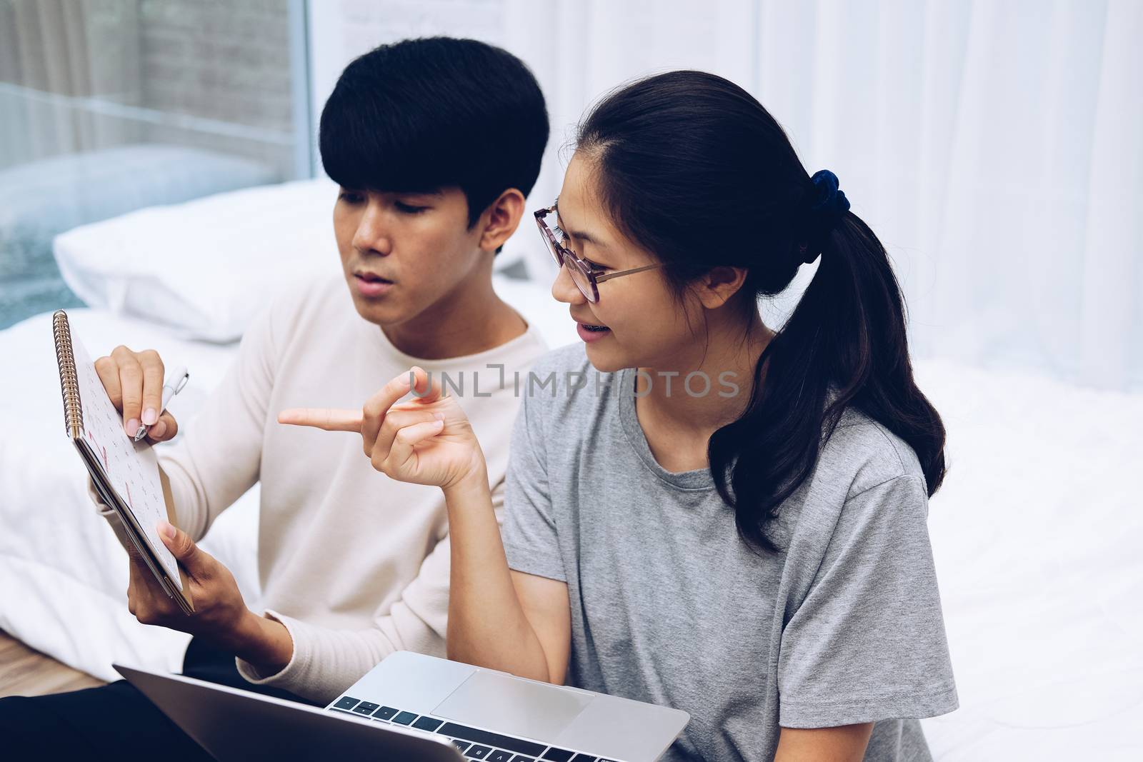 man woman friends discussing plan on calender using computer. startup teamwork team working together at home office