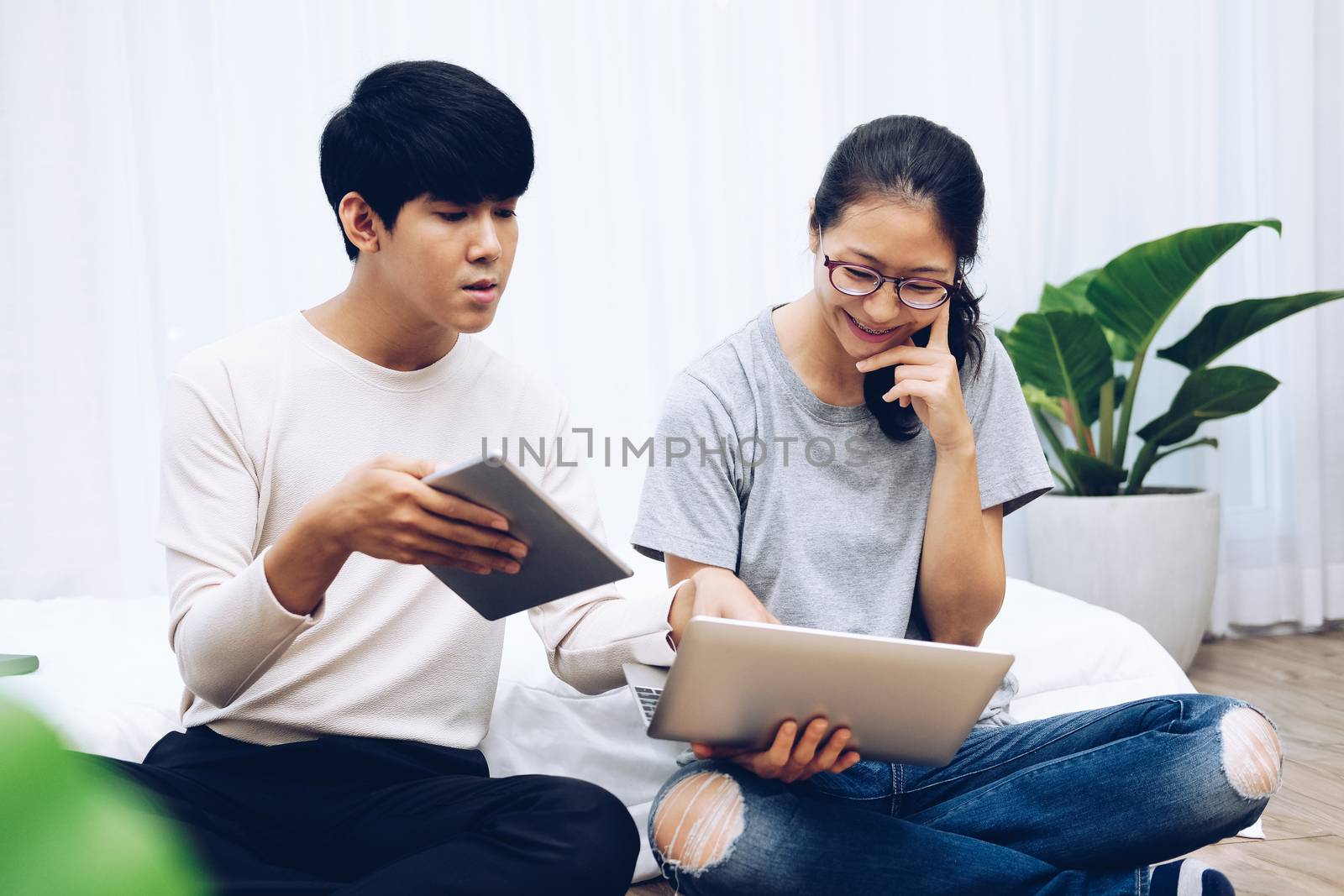 man woman friends using computer tablet. startup teamwork team working together at home