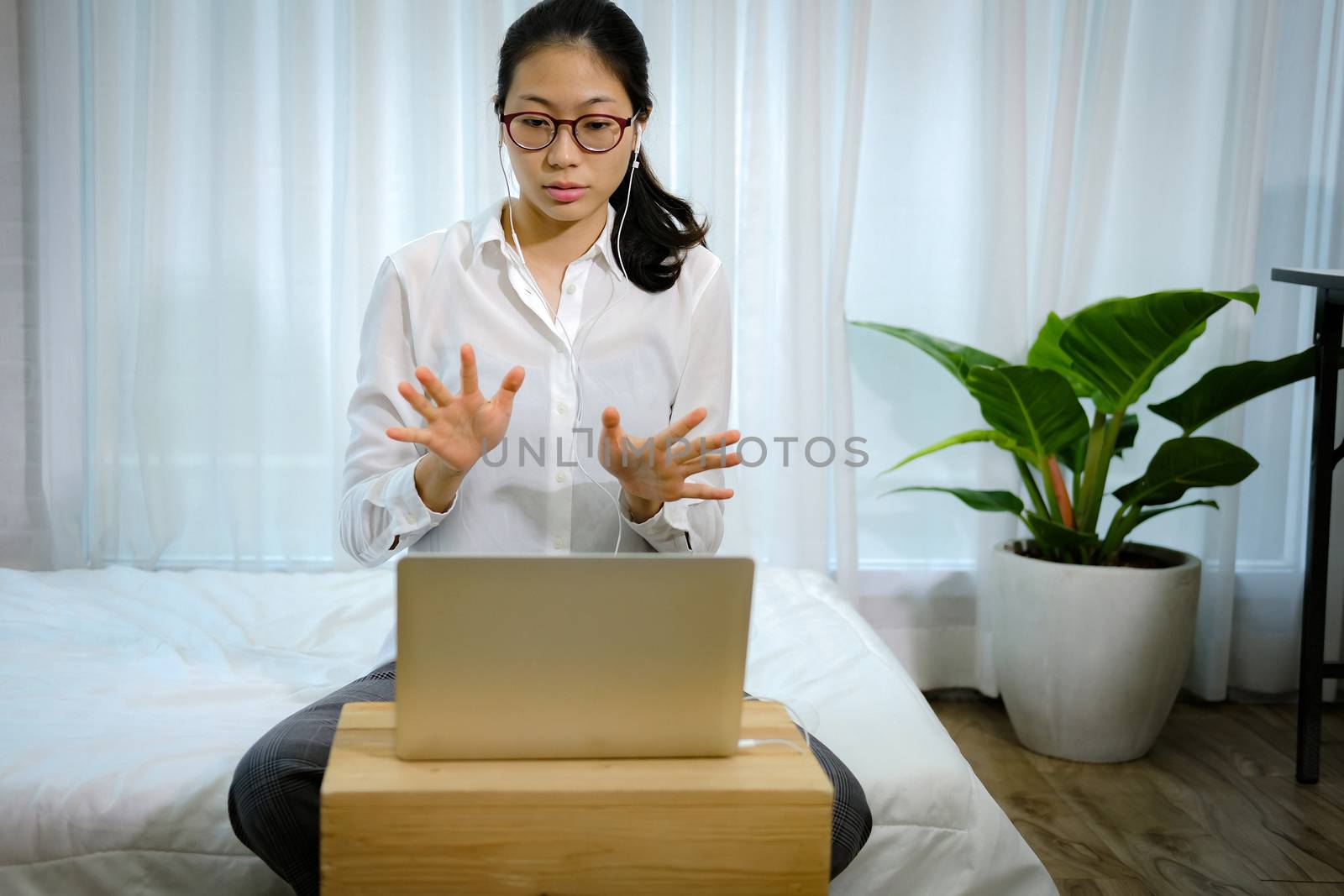 asian woman businesswoman talking with colleagues in online video conference meeting. work at home social distancing concept