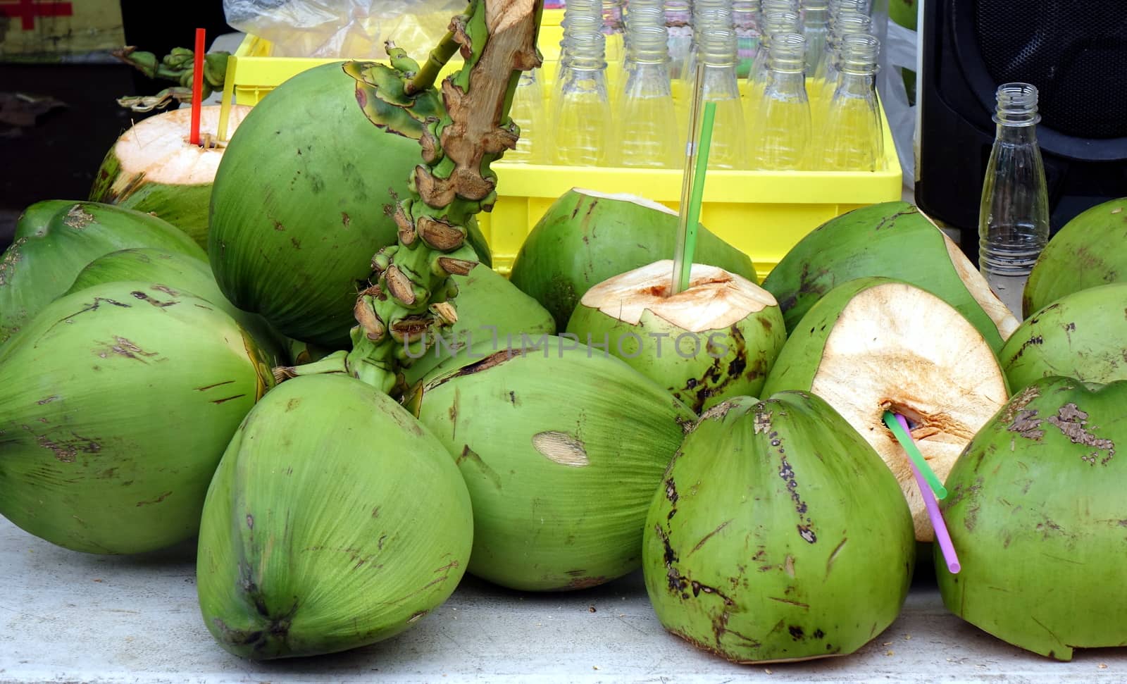 A street vendor sells fresh coconut milk straight from the fruit
